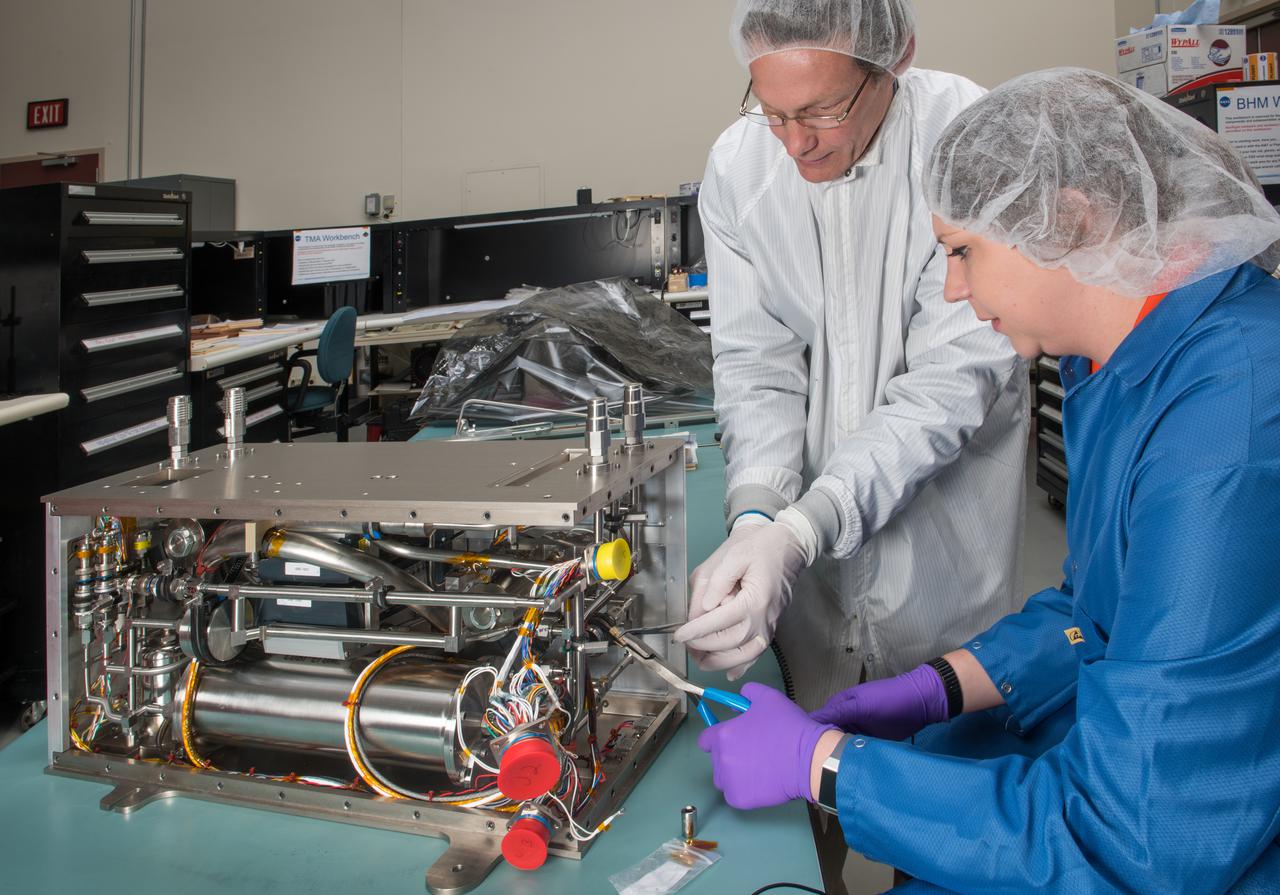 Flow Boiling and Condensation Experiment (FBCE) hardware. Project personnel perform engineering checks on the Fluid Module 1 prior to final hardware assembly.