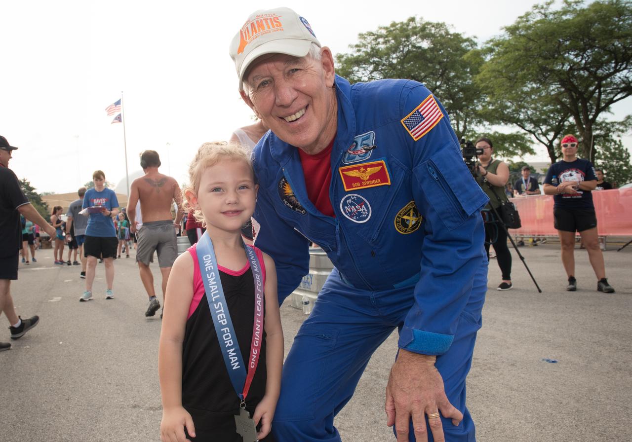 Astronaut Robert Springer congratulates who earned a medal in the 1-mile Fun Run during the  Summer Moon Festival, Wapakoneta, Ohio, Apollo 11 Moon Landing 50th Anniversary, Run To The Moon Race