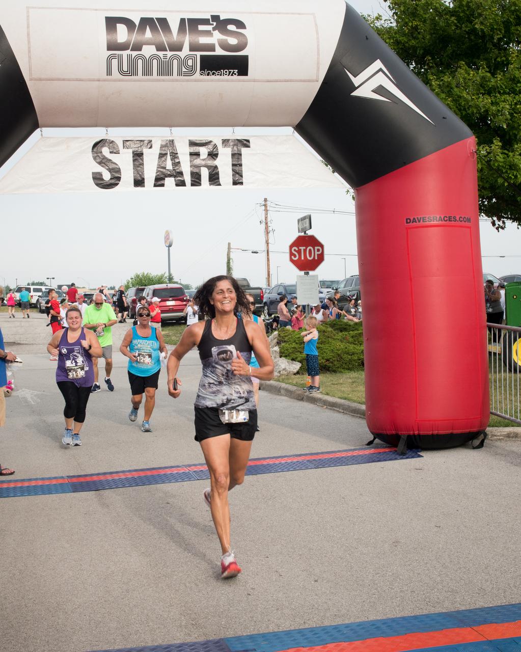 Astronaut Sunita Williams crosses the finish line of the Run To The Moon Race during the Summer Moon Festival, Wapakoneta, Ohio, Apollo 11 Moon Landing 50th Anniversary
