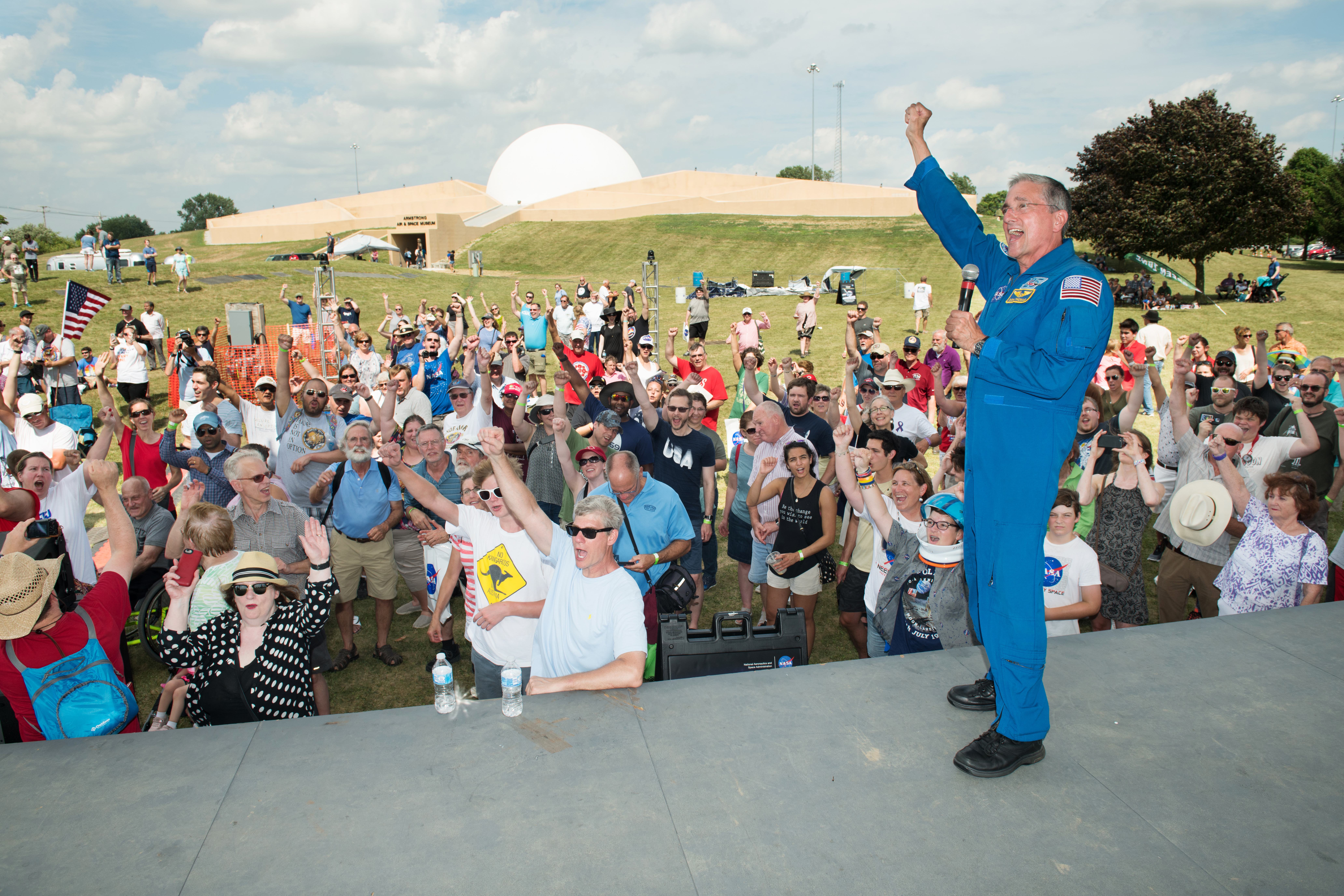 Astronaut Don Thomas and the crowd cheer at the moment of the Apollo 11 touchdown on the Moon during a replay of the 1969 television broadcast at the Summer Moon Festival, Wapakoneta, Ohio, Apollo 11 Moon Landing 50th Anniversary