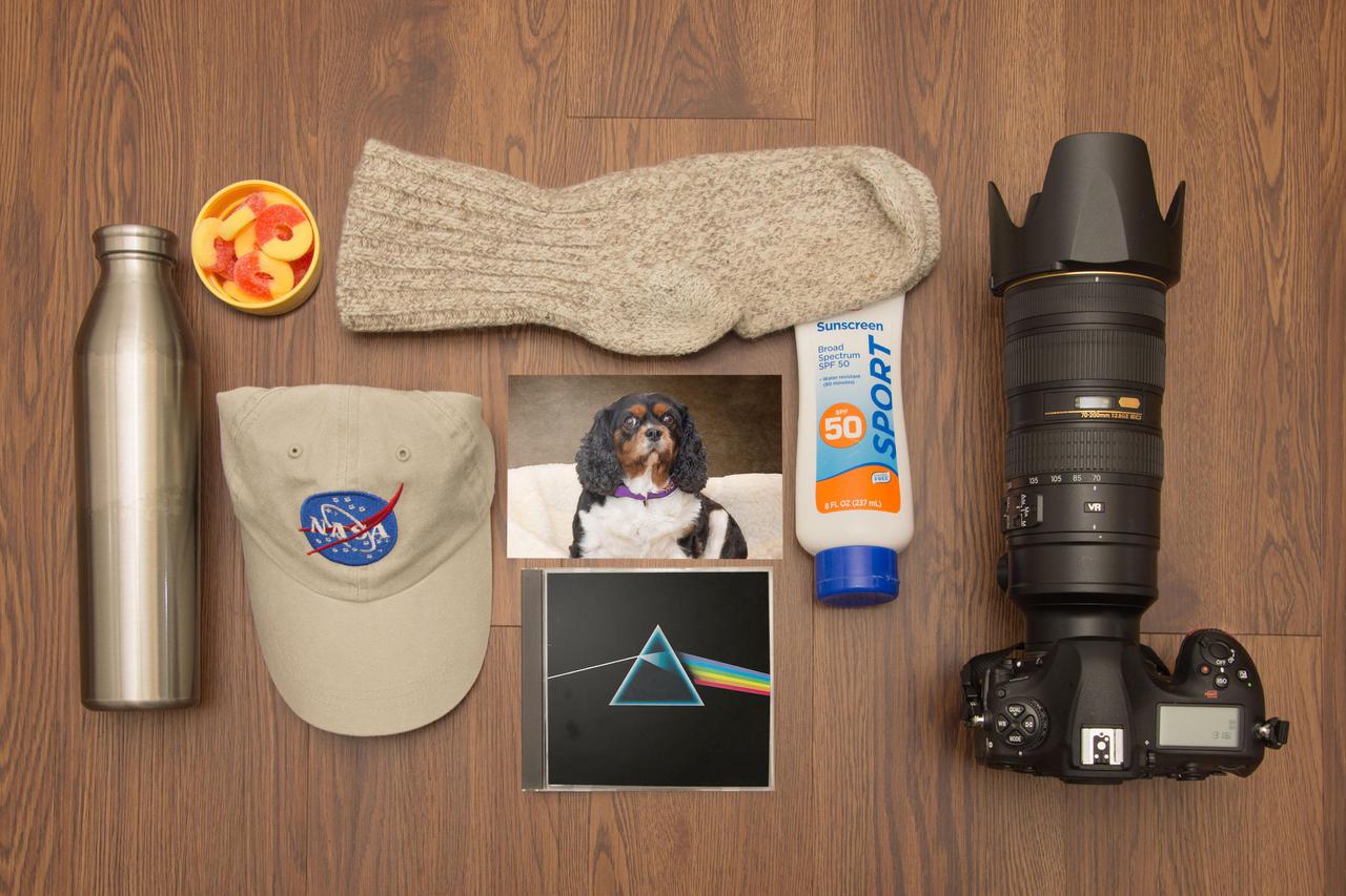 The first thing that went into my Moonkit was my camera.  Some of the most iconic photographs ever taken were captured on the surface of the Moon by NASA astronauts.  The camera has to go.  The hat and sunscreen will be a must to protect me from the unfiltered sunlight.  Warm socks?  Of course, my feet are always cold.  A little “Moon Music” and a photo of Holly, the best dog in the world, will pass the time during breaks.  Lastly, I need to eat.  Water and gummy peach rings will pack in a small corner of my pack.  Marv Smith Lead Photographer, NASA Glenn Research Center 