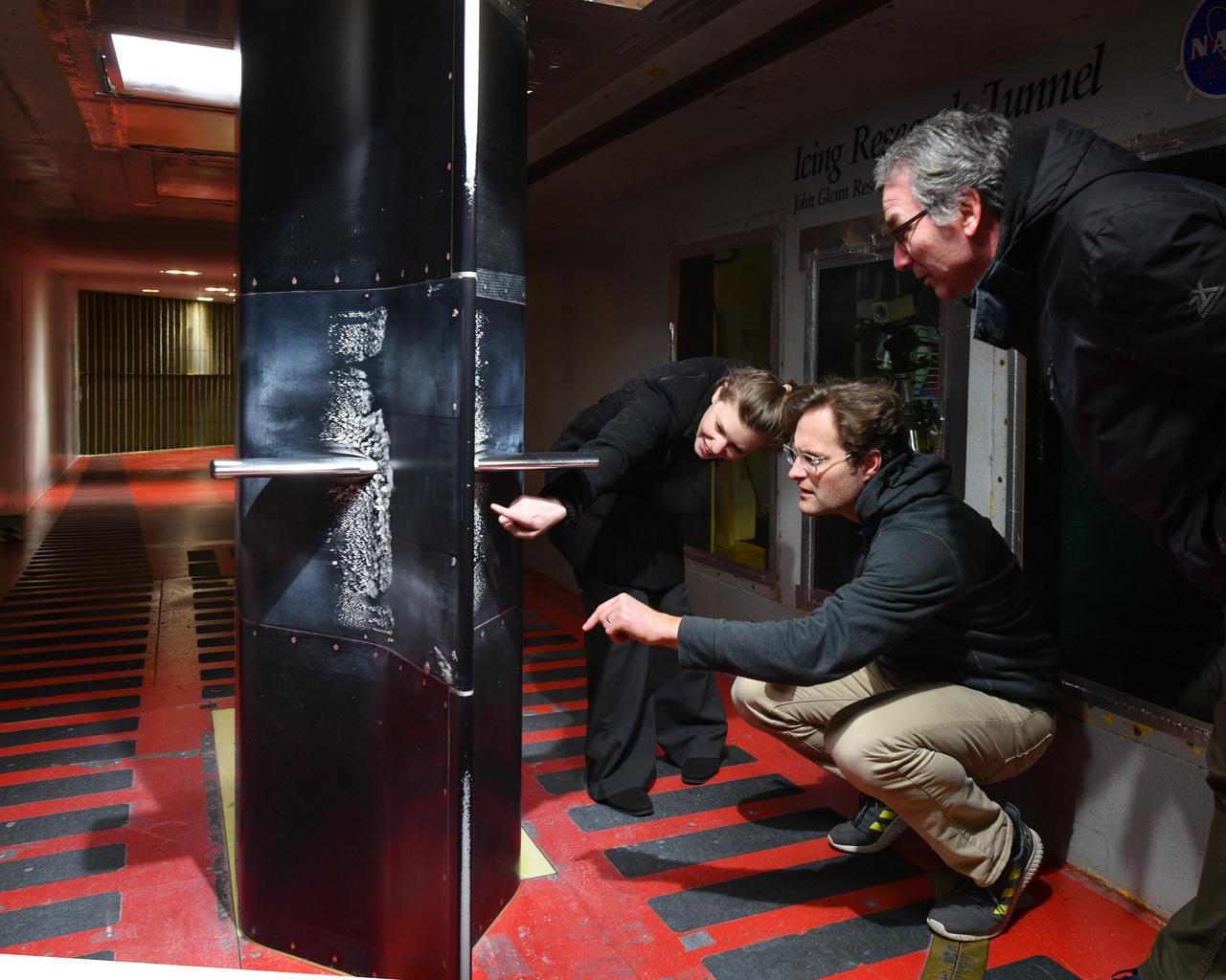 Pictured is a model to study the ice collection on struts in jet engines during flight. Researchers inspect the ice after the model encounters a simulated icing cloud during testing.  Super cooled water created from the icing cloud that flows though the wind tunnel.  The super cooled water forms ice on contact with the test model.  Researchers then inspect the ice formation before laser scanning of the ice formation for further research and analysis.