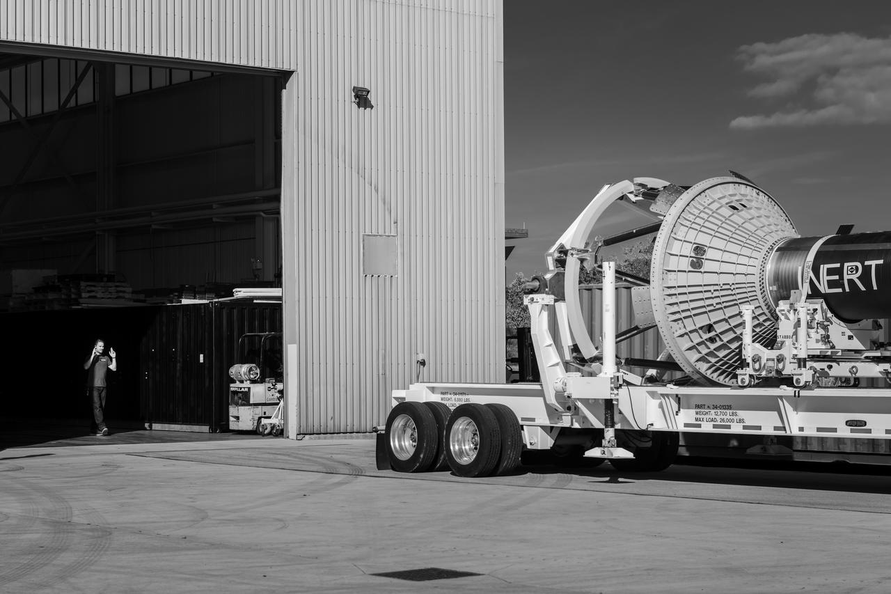 An engineer signals the truck driver carrying Orion’s Launch Abort System (LAS) at the Space Environments Complex. The LAS was awaiting Orion’s Crew Capsule to be tested on for mission critical support for Artemis II. Photo Credit: (NASA/Jordan Salkin)