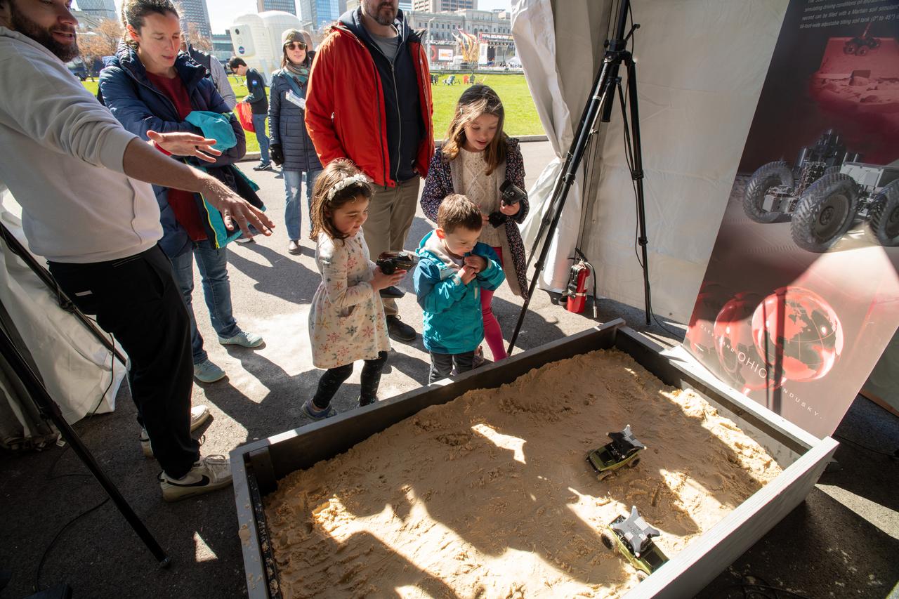 Guests interact with the VIPER exhibit at the Total Solar Eclipse Fest at the Great Lakes Science Center in Cleveland, OH on April 6, 2024. A total solar eclipse swept across a narrow portion of the North American continent from Mexico’s Pacific coast to the Atlantic coast of Newfoundland, Canada. A partial solar eclipse was visible across the entire North American continent along with parts of Central America and Europe. Photo Credit: (NASA/Sara Lowthian-Hanna)