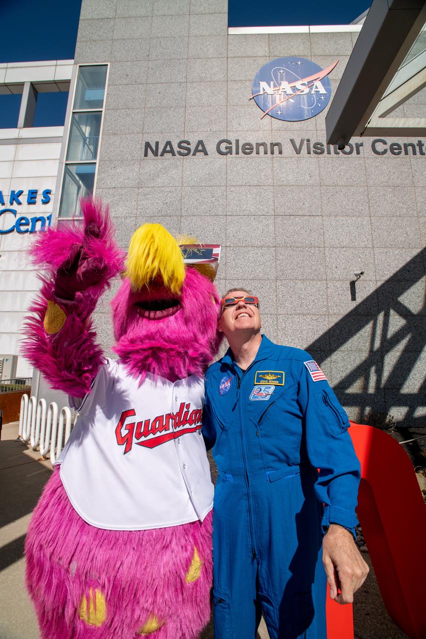 The Cleveland Guardians mascot, Slider and Astronaut Stephen Bowen view the solar eclipse at the Total Solar Eclipse Fest at the Great Lakes Science Center on April 6, 2024.  A total solar eclipse swept across a narrow portion of the North American continent from Mexico’s Pacific coast to the Atlantic coast of Newfoundland, Canada. A partial solar eclipse was visible across the entire North American continent along with parts of Central America and Europe.