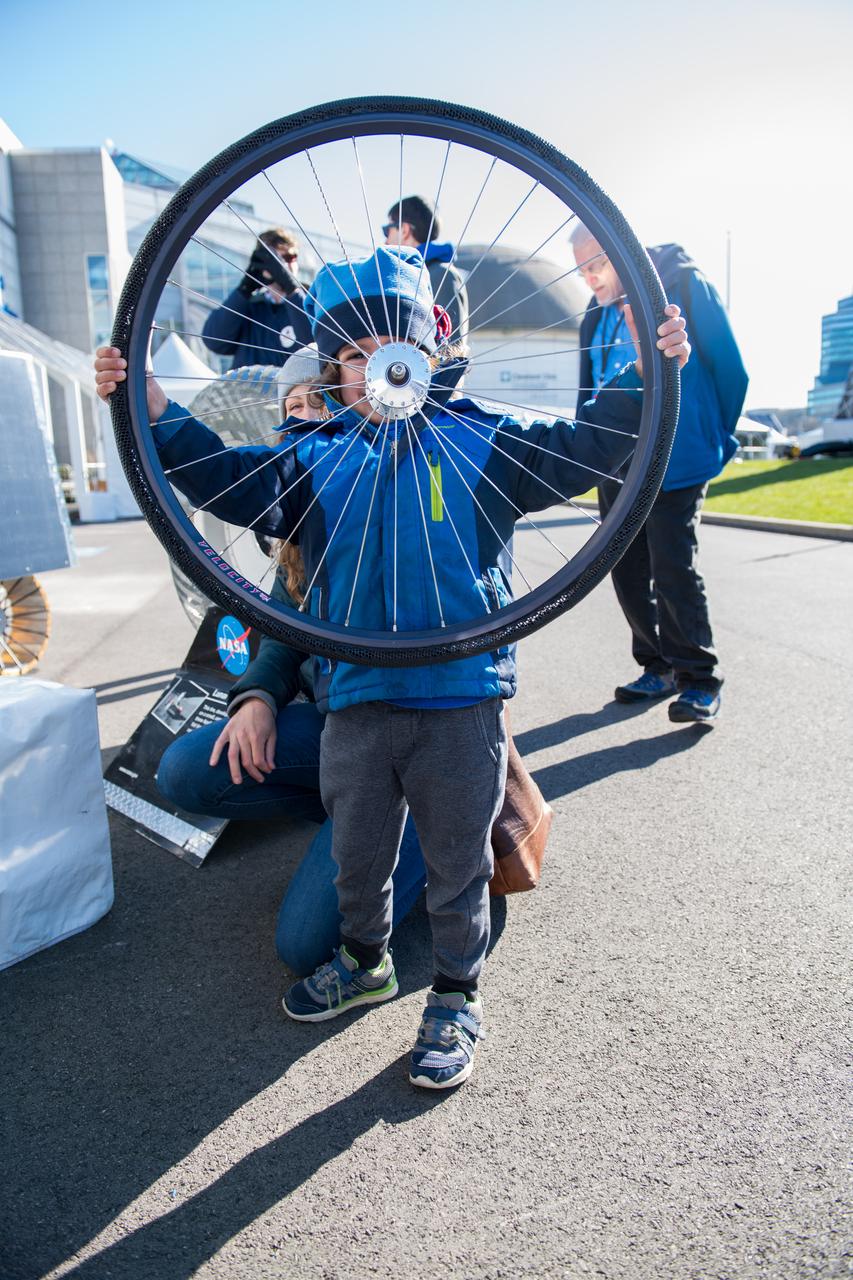 An event attendee holds a bike tire made with shape memory alloys at the Total Eclipse Fest at the Great Lakes Science Center in Cleveland, OH on April 7, 2024. A total solar eclipse swept across a narrow portion of the North American continent from Mexico’s Pacific coast to the Atlantic coast of Newfoundland, Canada. A partial solar eclipse was visible across the entire North American continent along with parts of Central America and Europe. Photo Credit: (NASA/Jef Janis)