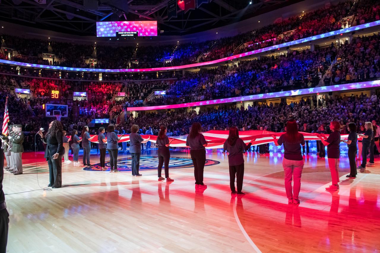 NASA women leaders present the flag at the NCAA championship game on Sunday, April 7th at Rocket Mortgage Fieldhouse in Cleveland, OH. 