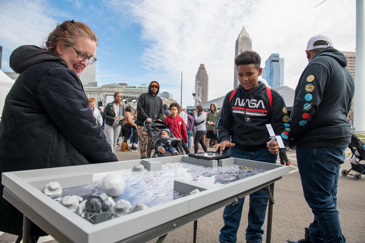 An event attendee interacts with one of the hands on science activities on April 7, 2024. NASA Glenn Research Center and the Great Lakes Science Center hosted a three-day celestial celebration in downtown Cleveland, OH. This free, outdoor, family-friendly science and arts festival will feature free concerts, performances, speakers, and hands-on science activities with community partners.