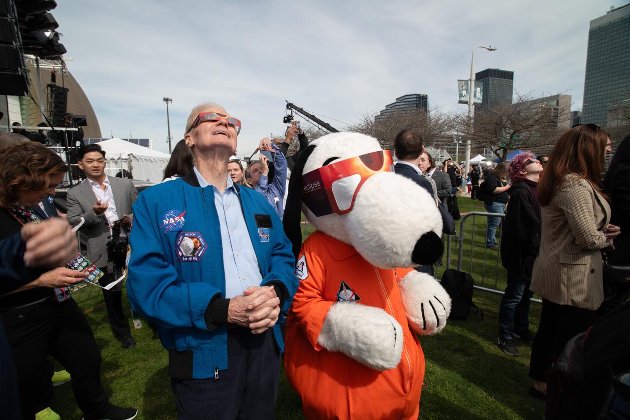 Administrator Bill Nelson and Snoopy view the eclipse just before totality on April 8,2024. NASA Glenn Research Center and the Great Lakes Science Center hosted a three-day celestial celebration in downtown Cleveland, OH. This free, outdoor, family-friendly science and arts festival will feature free concerts, performances, speakers, and hands-on science activities with community partners. A total solar eclipse swept across a narrow portion of the North American continent from Mexico’s Pacific coast to the Atlantic coast of Newfoundland, Canada. A partial solar eclipse was visible across the entire North American continent along with parts of Central America and Europe. Photo Credit: (NASA/Sara Lowthian-Hanna)