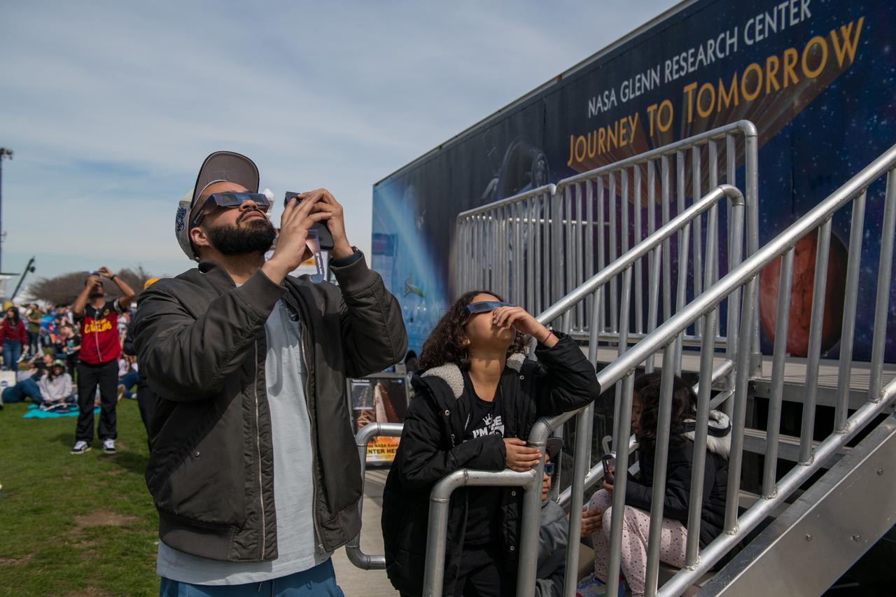 Event attendees view the eclipse on April 8, 2024. NASA Glenn Research Center and the Great Lakes Science Center hosted a three-day celestial celebration in downtown Cleveland, OH. This free, outdoor, family-friendly science and arts festival will feature free concerts, performances, speakers, and hands-on science activities with community partners. A total solar eclipse swept across a narrow portion of the North American continent from Mexico’s Pacific coast to the Atlantic coast of Newfoundland, Canada. A partial solar eclipse was visible across the entire North American continent along with parts of Central America and Europe. Photo Credit: (NASA/Jef Janis)