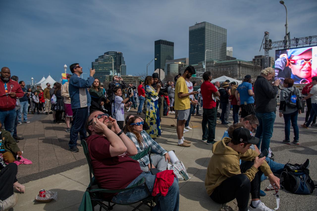 Event attendees view the total solar eclipse on April 8, 2024. NASA Glenn Research Center and the Great Lakes Science Center hosted a three-day celestial celebration in downtown Cleveland, OH. This free, outdoor, family-friendly science and arts festival will feature free concerts, performances, speakers, and hands-on science activities with community partners. A total solar eclipse swept across a narrow portion of the North American continent from Mexico’s Pacific coast to the Atlantic coast of Newfoundland, Canada. A partial solar eclipse was visible across the entire North American continent along with parts of Central America and Europe. Photo Credit: (NASA/Jef Janis)
