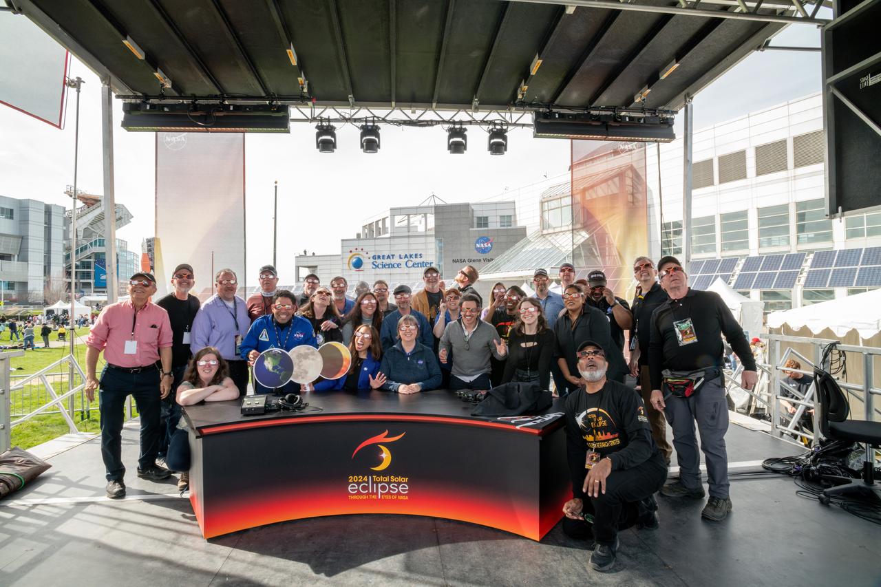 Team photo of those involved in NASA TV’s live coverage of the total solar eclipse on April 8, 2024.  A total solar eclipse swept across a narrow portion of the North American continent from Mexico’s Pacific coast to the Atlantic coast of Newfoundland, Canada. A partial solar eclipse was visible across the entire North American continent along with parts of Central America and Europe. Photo Credit: (NASA/Sara Lowthian-Hanna)