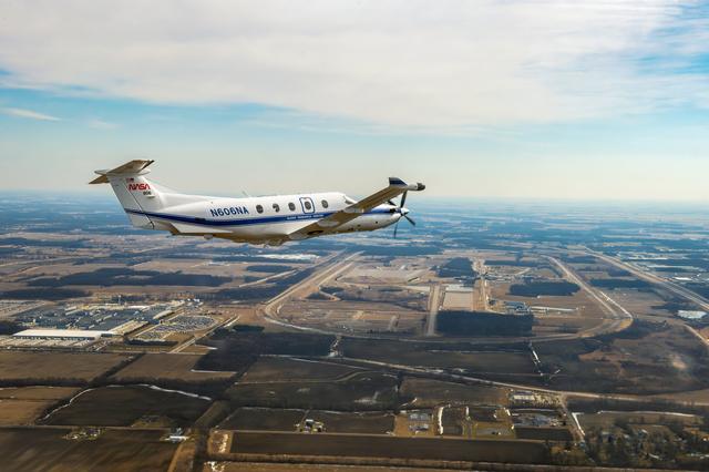 NASA image: Pilatus PC-12 aircraft in flight over the Cleveland area and the