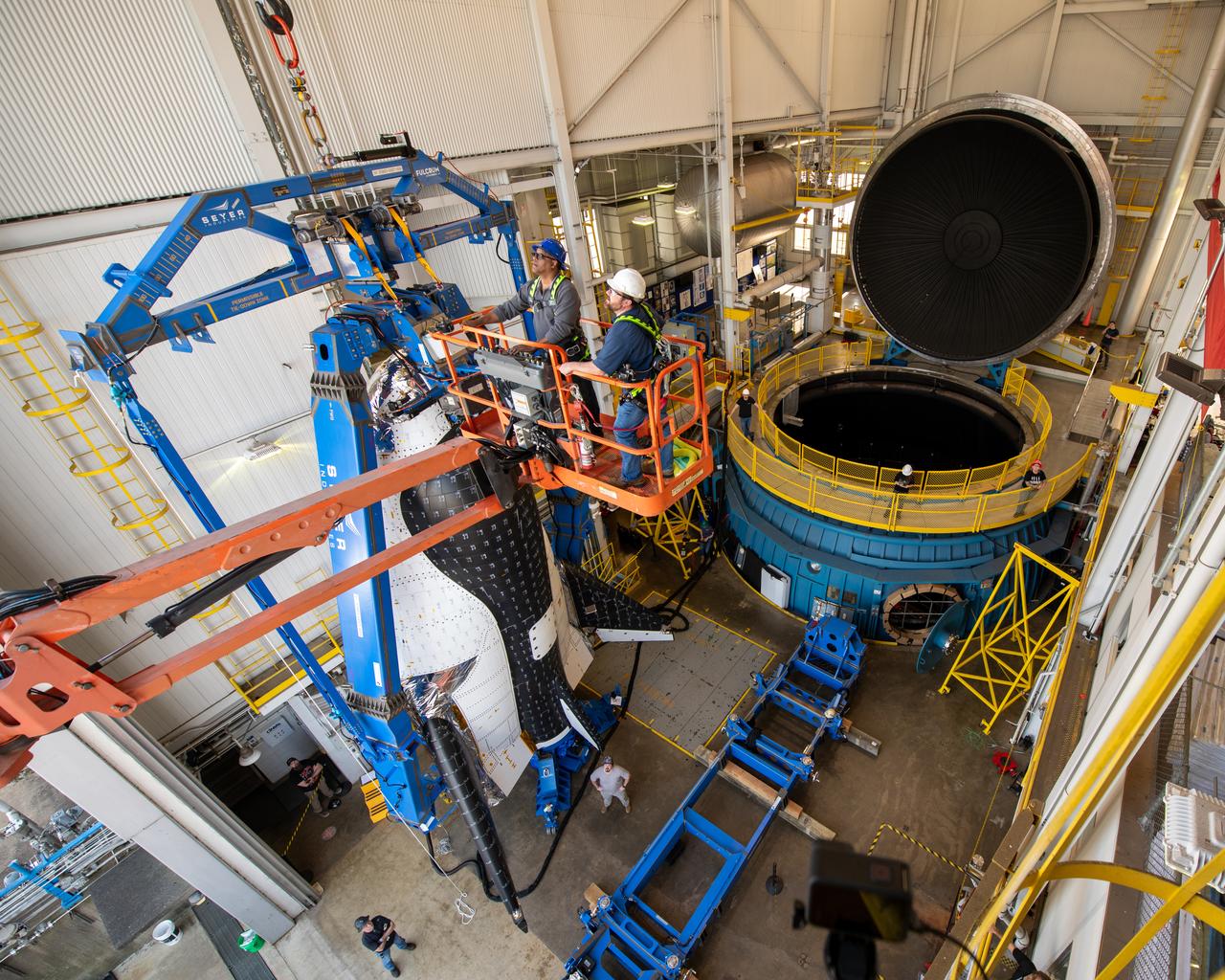 Final inspection of the crane operation just before the critical lift of the Sierra Space Plane, Dream Chaser.  It will go into the chamber at ISP (In Space Propulsion) NASA GRC-ATF.  Once lowered into the test chamber, it will be exposed to the harsh cold conditions of space for extended periods of time at building 3211 at ATF (Armstrong Test Facility) for environmental testing.