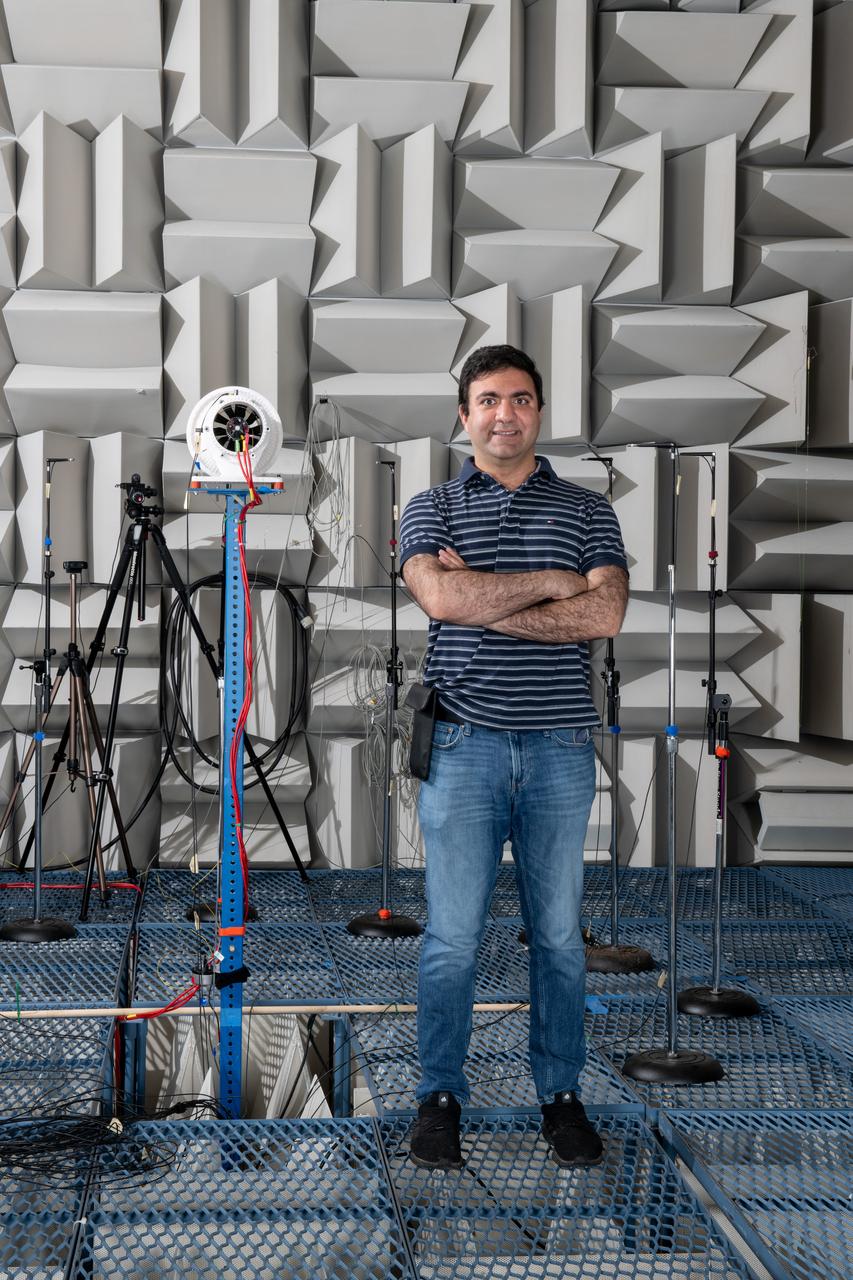 The Quiet Electric Engine V1 (QUEEN V1) experiment that was performed in the NASA GRC Acoustical Testing Laboratory (ATL). Equipment is installed in the anechoic chamber and in the adjacent control room. In response to the pervasive health and environmental problems associated with aviation noise and air pollution, NASA’s Quiet Electric Engine (QUEEN) team is working to increase the peace and quiet in the world by researching ways to make engines for large single-aisle aircraft safer, cleaner, and quieter. Posing with the experiment is aerospace engineer, Jonathan M. Goodman.