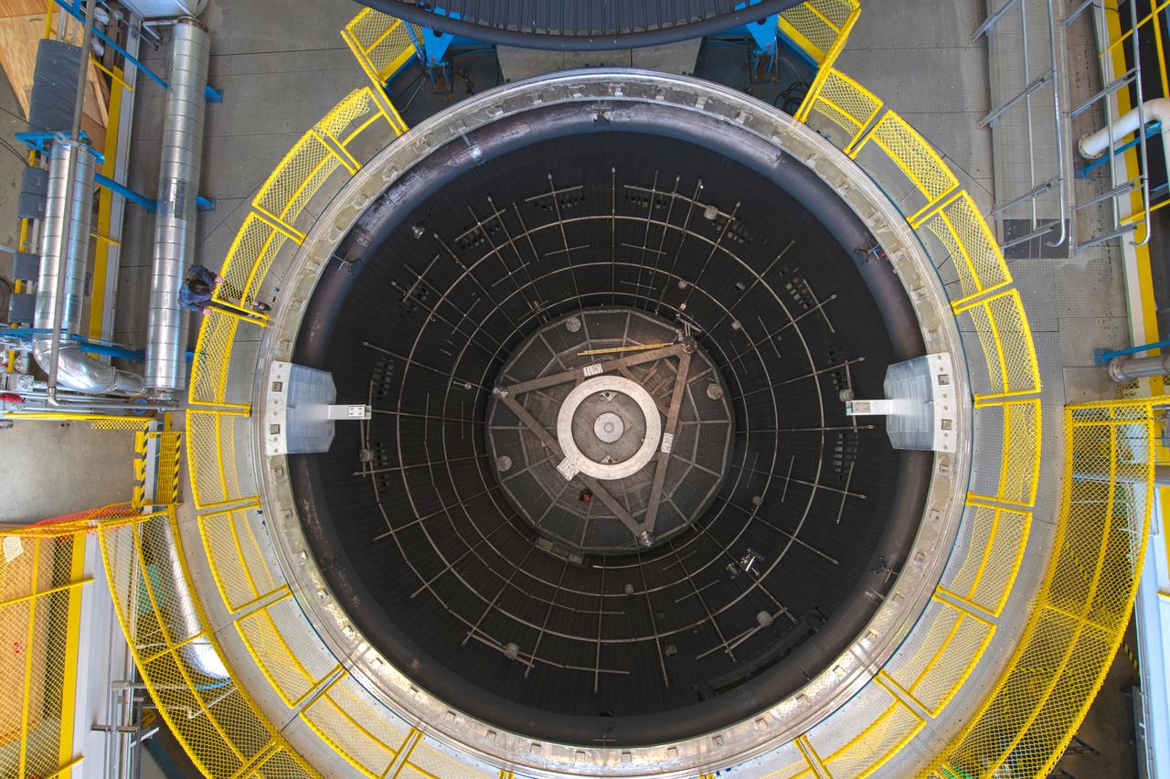 The test chamber is 38 ft in diameter by 62 ft deep amd  made of stainless steel. It is vacuum rated at 10-7 torr long duration (Local atmospheric pressure to 100 statute miles altitude). The vacuum chamber surfaces are lined with a liquid nitrogen cold wall, capable of maintaining -320 °F. A quartz infrared heating system can be programmed to radiate a sinusoidal distribution, simulating rotational solar heating. Photo Credit: (NASA/Quentin Schwinn)