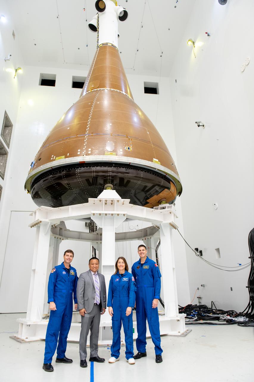 Commander Reid Wiseman, Howard Hu, Mission Specialist Christina Koch and Mission Specialist Jeremy Hansen pose in front of the Orion Environmental Test Article at Armstrong Test Facility in Sandusky, OH on September 11, 2024.   The team has begun vibro-acoustic testing on the Orion spacecraft that flew around the Moon on Artemis I, now known as the Environmental Test Article. The testing will help ensure the safety of future crews aboard Orion.  Employees meet three of the four astronauts who will venture around the Moon on Artemis II, the first crewed flight paving the way for future lunar surface missions. Commander Reid Wiseman and Mission Specialists Christina Koch and Jeremy Hansen will be on hand to discuss their upcoming mission and participate in a Question and Answer session with employees afterward. Hansen is an astronaut with the Canadian Space Agency. Victor Glover, the pilot and fourth crew member, will not be present.  Awards were given to employees that participated in Orion for Artemis I. Photo Credit: (NASA/Sara Lowthian-Hanna)