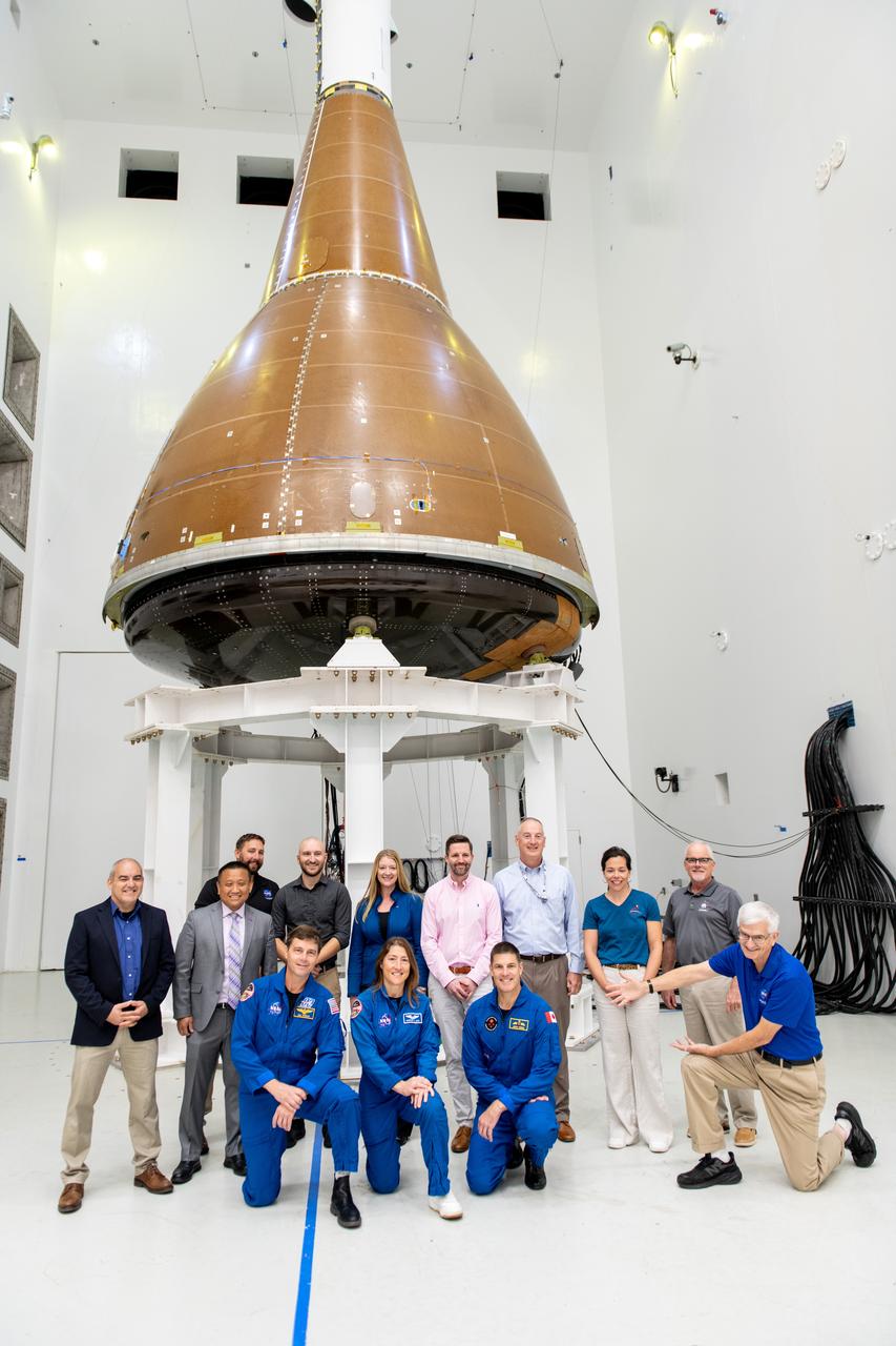 Front Row: Commander Reid Wiseman, Howard Hu, Mission Specialist Christina Koch, Mission Specialist Jeremy Hansen, General David Stringer, Back Row: Carlos Garcia Galan, Howard Hu, John Zang, Josh Pawlak, Nicole Smith, Jan-Henrik Horstmann, Robert Overy, Kathryn Oriti pose in front of the Orion Environmental Test Article at Armstrong Test Facility in Sandusky, OH.  The team has begun vibro-acoustic testing on the Orion spacecraft that flew around the Moon on Artemis I, now known as the Environmental Test Article. The testing will help ensure the safety of future crews aboard Orion.  Employees meet three of the four astronauts who will venture around the Moon on Artemis II, the first crewed flight paving the way for future lunar surface missions. Commander Reid Wiseman and Mission Specialists Christina Koch and Jeremy Hansen will be on hand to discuss their upcoming mission and participate in a Question and Answer session with employees afterward. Hansen is an astronaut with the Canadian Space Agency. Victor Glover, the pilot and fourth crew member, will not be present.  Awards were given to employees that participated in Orion for Artemis I. Photo Credit: (NASA/Sara Lowthian-Hanna)