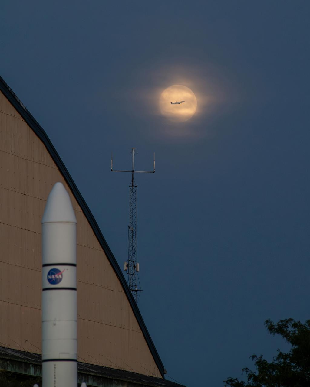 While photographing the Supermoon on September 17, 2024 for a NASA GRC Aerospace Frontiers article on the 2024 Supermoon, a plane departing Cleveland Hopkins Airport flew right through the middle of the moon. The photographer used a portion of the rocket garden’s Ares 1 rocket and a corner of the NASA GRC hangar building to frame the photograph of the moon. When the plane was seen approaching, the photographer used continuous shutter speed in hopes of capturing the plane and the moon together.