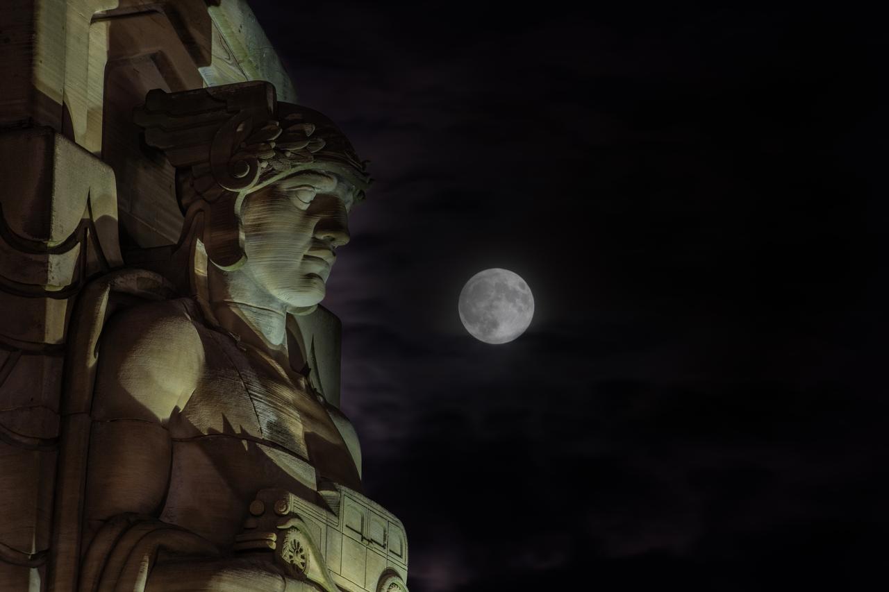 Guardians of Traffic Statue in Cleveland, OH in front of the Supermoon that was visible on September 17th, 2024. On this day, the full moon was a partial lunar eclipse; a supermoon; and a harvest moon. Photo Credit: (NASA/Sara Lowthian-Hanna)