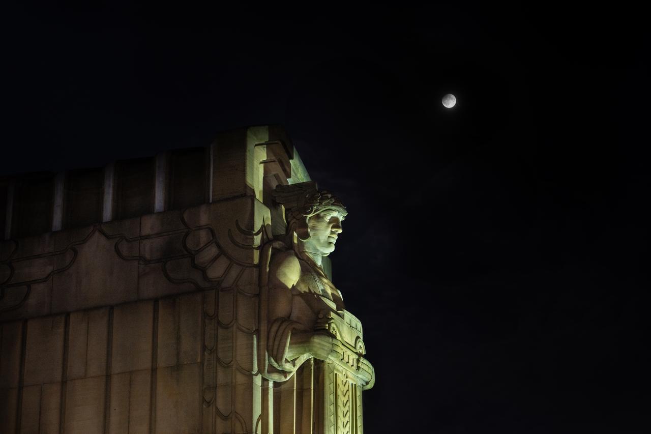 Guardians of Traffic Statue in Cleveland, OH in front of the Supermoon that was visible on September 17th, 2024. On this day, the full moon was a partial lunar eclipse; a supermoon; and a harvest moon.