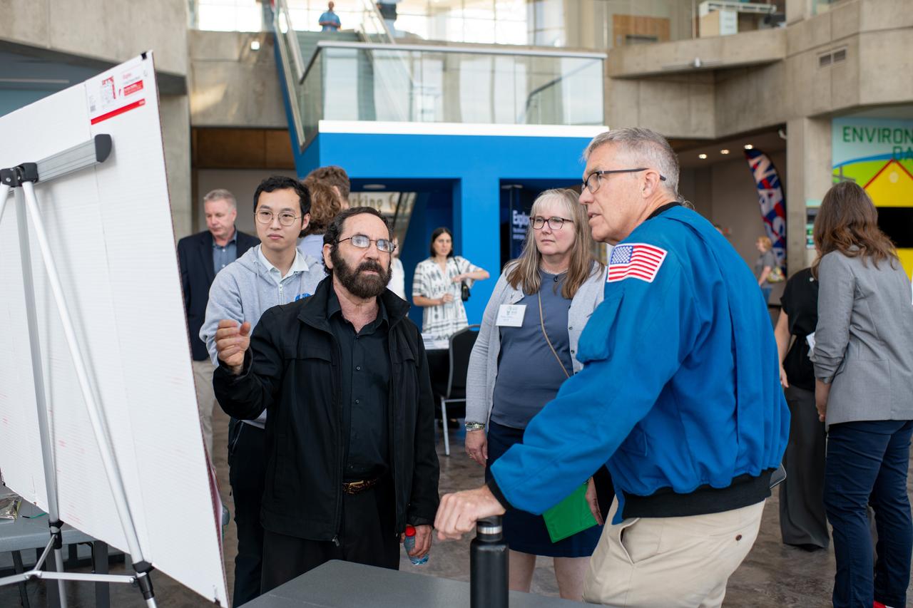 Philip Lubin from Team H.E.L.P.S. (High Efficiency Long-Range Power Solution) explains his project to Mary Wadel and Stephen Bowen.  NASA has awarded a total of $1.5 million to two U.S. teams for their novel technology solutions addressing energy distribution, management, and storage as part of the agency’s Watts on the Moon Challenge. The innovations from this challenge aim to support NASA’s Artemis missions, which will establish long-term human presence on the Moon.  This two-phase competition has challenged U.S. innovators to develop breakthrough power transmission and energy storage technologies that could enable long-duration Moon missions to advance the nation’s lunar exploration goals. The final phase of the challenge concluded with a technology showcase and winners’ announcement ceremony on September 20, 2024 at Great Lakes Science Center, home of the visitor center for NASA’s Glenn Research Center in Cleveland.  Team H.E.L.P.S. (High Efficiency Long-Range Power Solution) from The University of California, Santa Barbara won the $1 million grand prize in NASA’s Watts on the Moon Challenge. Their team developed a low-mass, high efficiency cable and featured energy storage batteries on both ends of their power transmission and energy storage system.  Second prize ($500,000): Orbital Mining Corporation of Golden, Colorado. Photo Credit: (NASA/Sara Lowthian-Hanna)