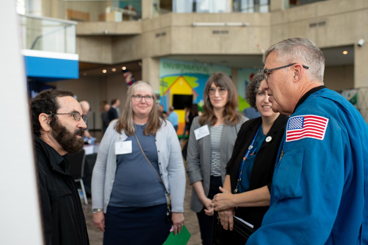 Philip Lubin from Team H.E.L.P.S. (High Efficiency Long-Range Power Solution)  explains his project to Mary Wadel, Lisa Ferguson, Kirsten Ellenbogen and Stephen Bowen.  NASA has awarded a total of $1.5 million to two U.S. teams for their novel technology solutions addressing energy distribution, management, and storage as part of the agency’s Watts on the Moon Challenge. The innovations from this challenge aim to support NASA’s Artemis missions, which will establish long-term human presence on the Moon.  This two-phase competition has challenged U.S. innovators to develop breakthrough power transmission and energy storage technologies that could enable long-duration Moon missions to advance the nation’s lunar exploration goals. The final phase of the challenge concluded with a technology showcase and winners’ announcement ceremony on September 20, 2024 at Great Lakes Science Center, home of the visitor center for NASA’s Glenn Research Center in Cleveland.  Team H.E.L.P.S. (High Efficiency Long-Range Power Solution) from The University of California, Santa Barbara won the $1 million grand prize in NASA’s Watts on the Moon Challenge. Their team developed a low-mass, high efficiency cable and featured energy storage batteries on both ends of their power transmission and energy storage system.  Second prize ($500,000): Orbital Mining Corporation of Golden, Colorado. Photo Credit: (NASA/Sara Lowthian-Hanna)