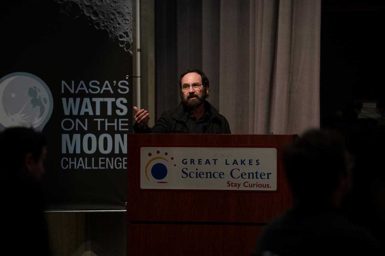 Philip Lubin from H.E.L.P.S. (High Efficiency Long-Range Power Solution) from The University of California gives their presentation.   NASA has awarded a total of $1.5 million to two U.S. teams for their novel technology solutions addressing energy distribution, management, and storage as part of the agency’s Watts on the Moon Challenge. The innovations from this challenge aim to support NASA’s Artemis missions, which will establish long-term human presence on the Moon.  This two-phase competition has challenged U.S. innovators to develop breakthrough power transmission and energy storage technologies that could enable long-duration Moon missions to advance the nation’s lunar exploration goals. The final phase of the challenge concluded with a technology showcase and winners’ announcement ceremony on September 11, 2024 at Great Lakes Science Center, home of the visitor center for NASA’s Glenn Research Center in Cleveland.  Team H.E.L.P.S. (High Efficiency Long-Range Power Solution) from The University of California, Santa Barbara won the $1 million grand prize in NASA’s Watts on the Moon Challenge. Their team developed a low-mass, high efficiency cable and featured energy storage batteries on both ends of their power transmission and energy storage system.  Second prize ($500,000): Orbital Mining Corporation of Golden, Colorado. Photo Credit: (NASA/Sara Lowthian-Hanna)