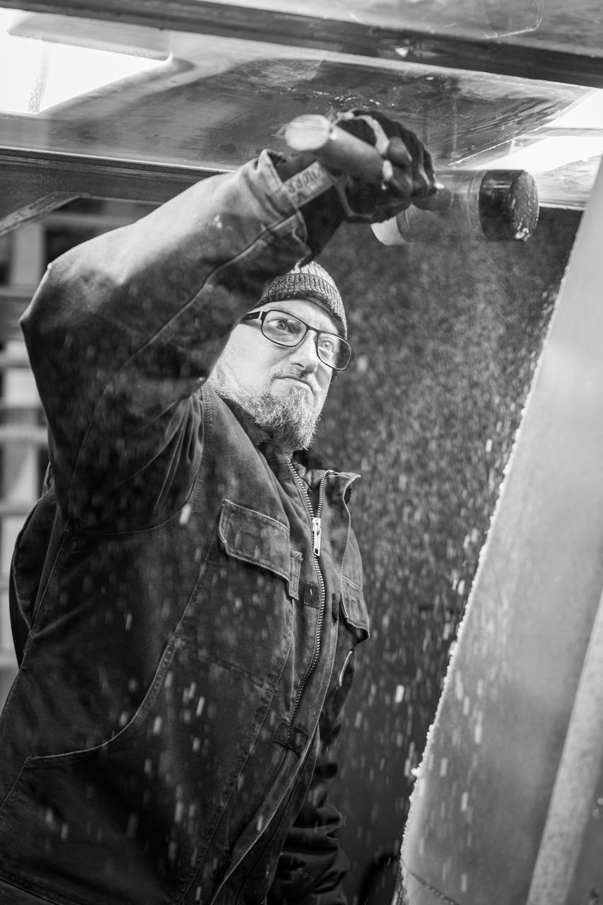 A technician is shown preparing the research model for its next test condition by removing ice accretion. Photo Credit: (NASA/Jordan Salkin)