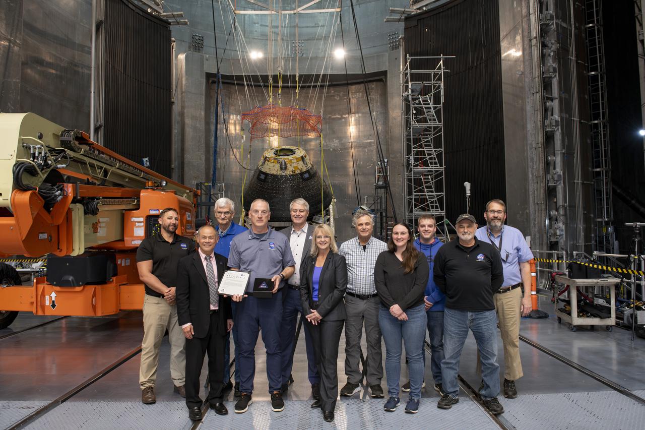 Employees supporting Artemis were invited to attend an appreciation event, “The Road to the Moon,” at Armstrong Test Facility in Sandusky, Ohio. Lockheed Martin presented an article flown on Artemis I to Robert Overy. Pictured from left to right: John Zang, Pho Nguyen, General David Stringer, Robert Overy, Paul Anderson, Debbie Korth, Aaron Horz, Emma Gaerke, Benjamin,  Michael Henry and Mark Cmar.    On Thursday, Nov. 21, please join NASA employees and support service contractors for Artemis Friends and Family Day. Employees had the opportunity to hear from center leadership and see the Orion module that flew around the Moon and back during 2022’s Artemis I mission.   Experts have subjected the spacecraft to extreme conditions in Armstrong’s test facilities. This significant testing is slated to wrap up in December, and we want to give you a chance to see the capsule before the conclusion of the test campaign. Photo Credit: (NASA/Sara Lowthian-Hanna)