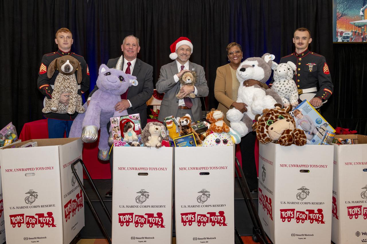 The US Marine Corps Reserve Collected Toy Donations for the 2024 Holiday Season.  Members of the Marine Corps, Associate Director Laurence Sivic, Center Director Dr. James Kenyon and Acting Deputy Center Director Dr. Wanda Peters pose with the toy donations. 