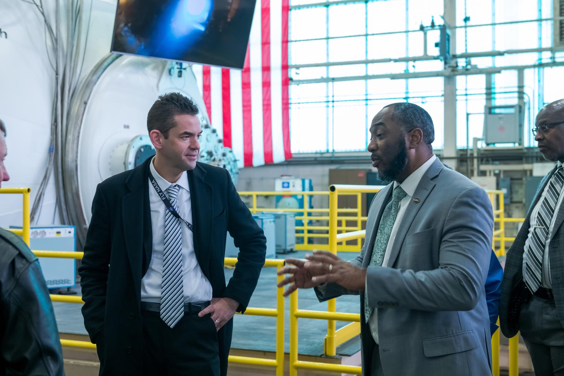 During a visit to NASA's Glenn Research Center in Cleveland on Tuesday, Jan. 27, 2026, NASA Administrator Jared Isaacman speaks with Carl Sandifer, manager of the Radioisotope Power Systems Program, inside the Electric Propulsion and Power Laboratory as Rickey Shyne, director of Research and Engineering, looks on.