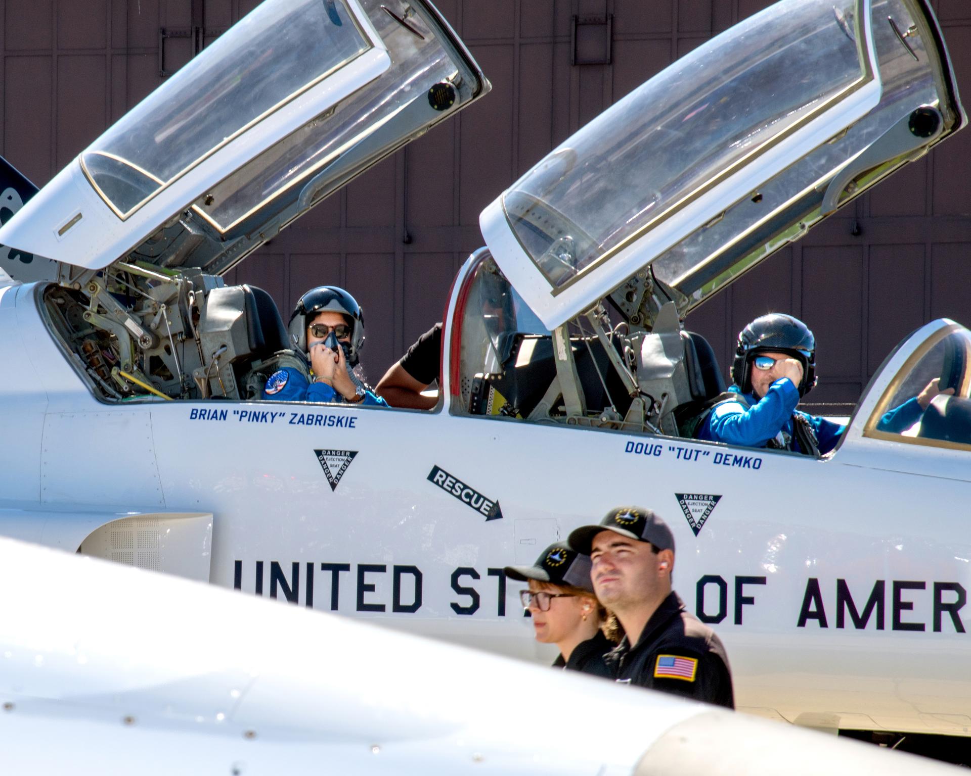 Rider Greeta Thaikattil talks with her pilot, Doug “Tut” Demko before engine start and take off for the Browns Stadium flyover. This was part of the 2026 NASA Inspiration Tours.