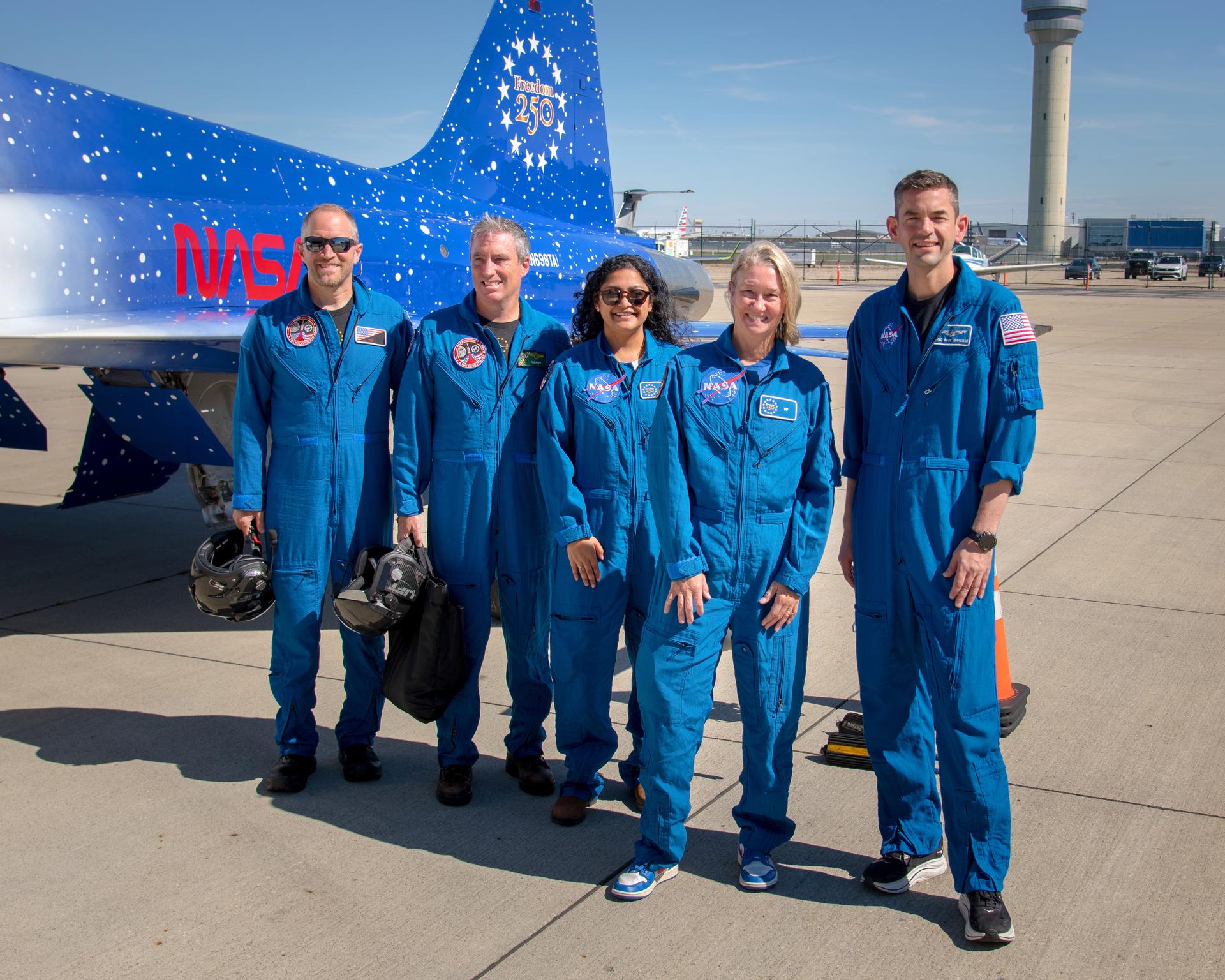 NASA Administrator Jared Isaacman and two GRC employees’ riders fly over the Cleveland browns football game start.The three pilots, Handy, Tut and Jared Isaacman, and the two riders, Greeta Thaikattil and Heather Brown, together for a photos after the flyover flight