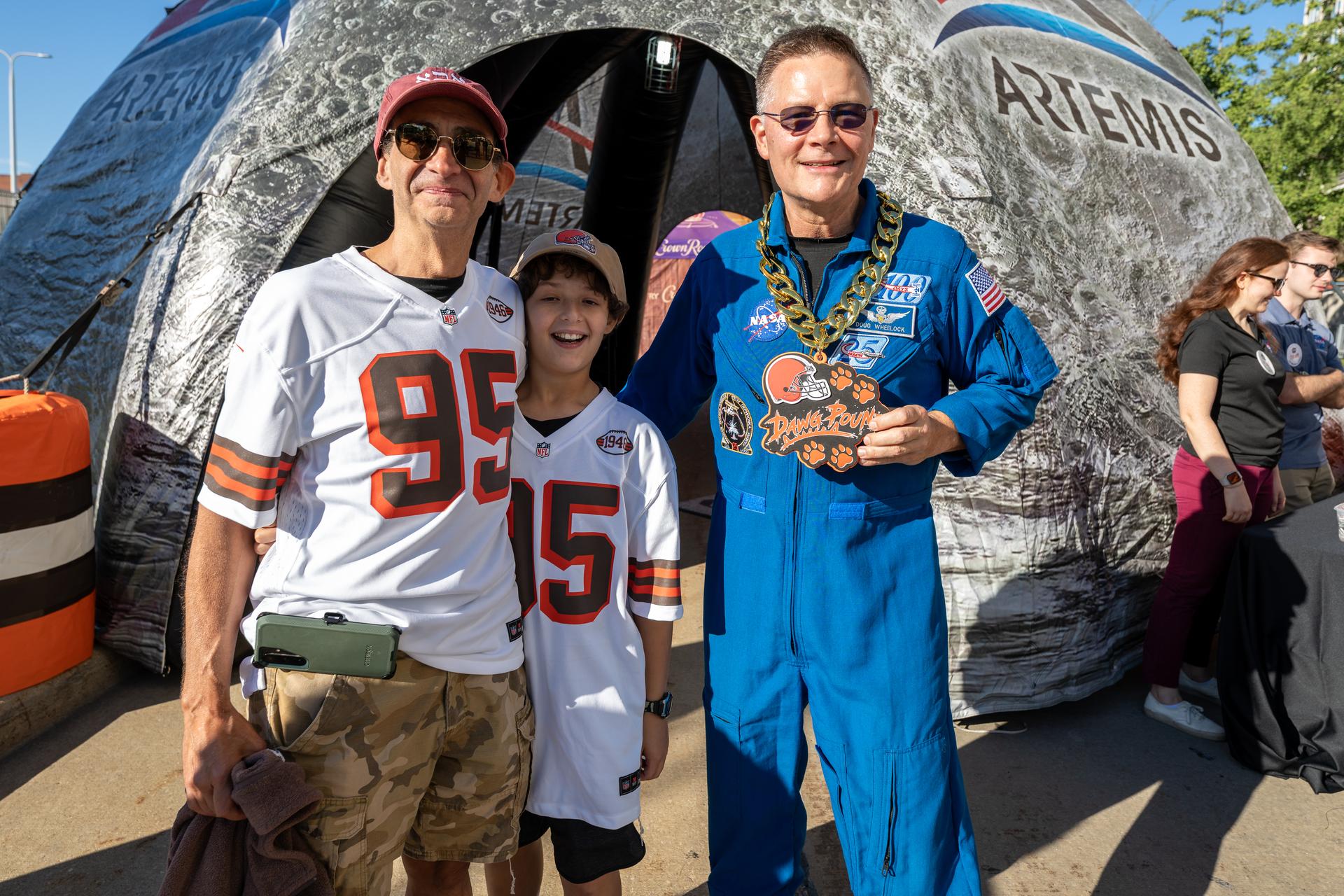 NASA Astronaut Douglas Wheelock poses with Browns' fans at an NFL game between the Cleveland Browns and the Carolina Panthers at Huntington Bank Field, Sunday, September 27th, 2026, in Cleveland, Ohio. NASA’s engagement at NFL games is part of the agency’s Inspiration Tour, aimed at strengthening connections between NASA and its partners and showcasing innovation in air and space in the lead up to the MAX POWER aerospace technology expo and airshow at the agency’s Kennedy Space Center in early November. Photo Credit: (NASA/Jordan Cochran)