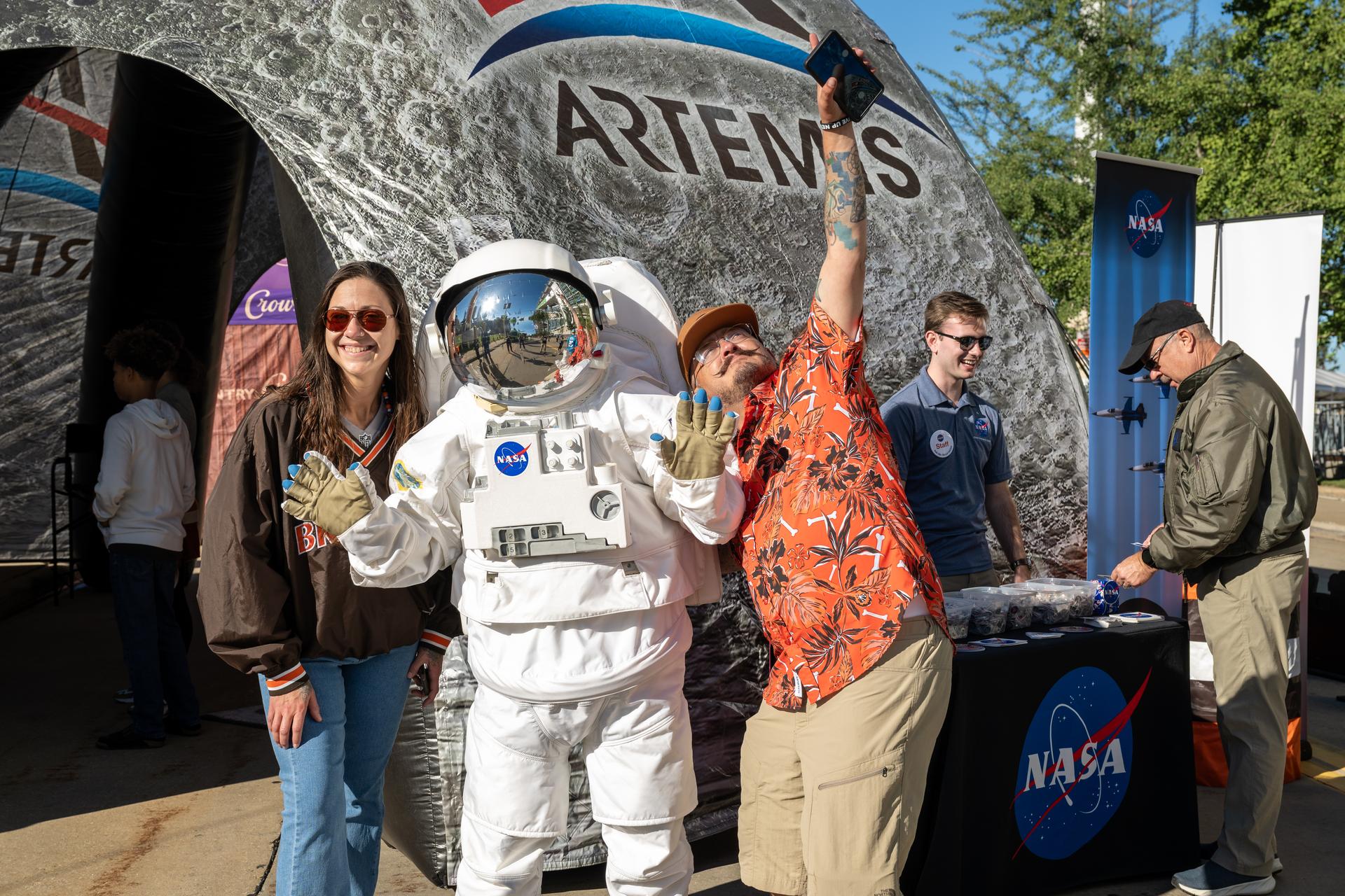 Eva the Astronaut poses with Browns' fans at an NFL game between the Cleveland Browns and the Carolina Panthers at Huntington Bank Field, Sunday, September 27th, 2026, in Cleveland, Ohio. NASA’s engagement at NFL games is part of the agency’s Inspiration Tour, aimed at strengthening connections between NASA and its partners and showcasing innovation in air and space in the lead up to the MAX POWER aerospace technology expo and airshow at the agency’s Kennedy Space Center in early November. Photo Credit: (NASA/Jordan Cochran)