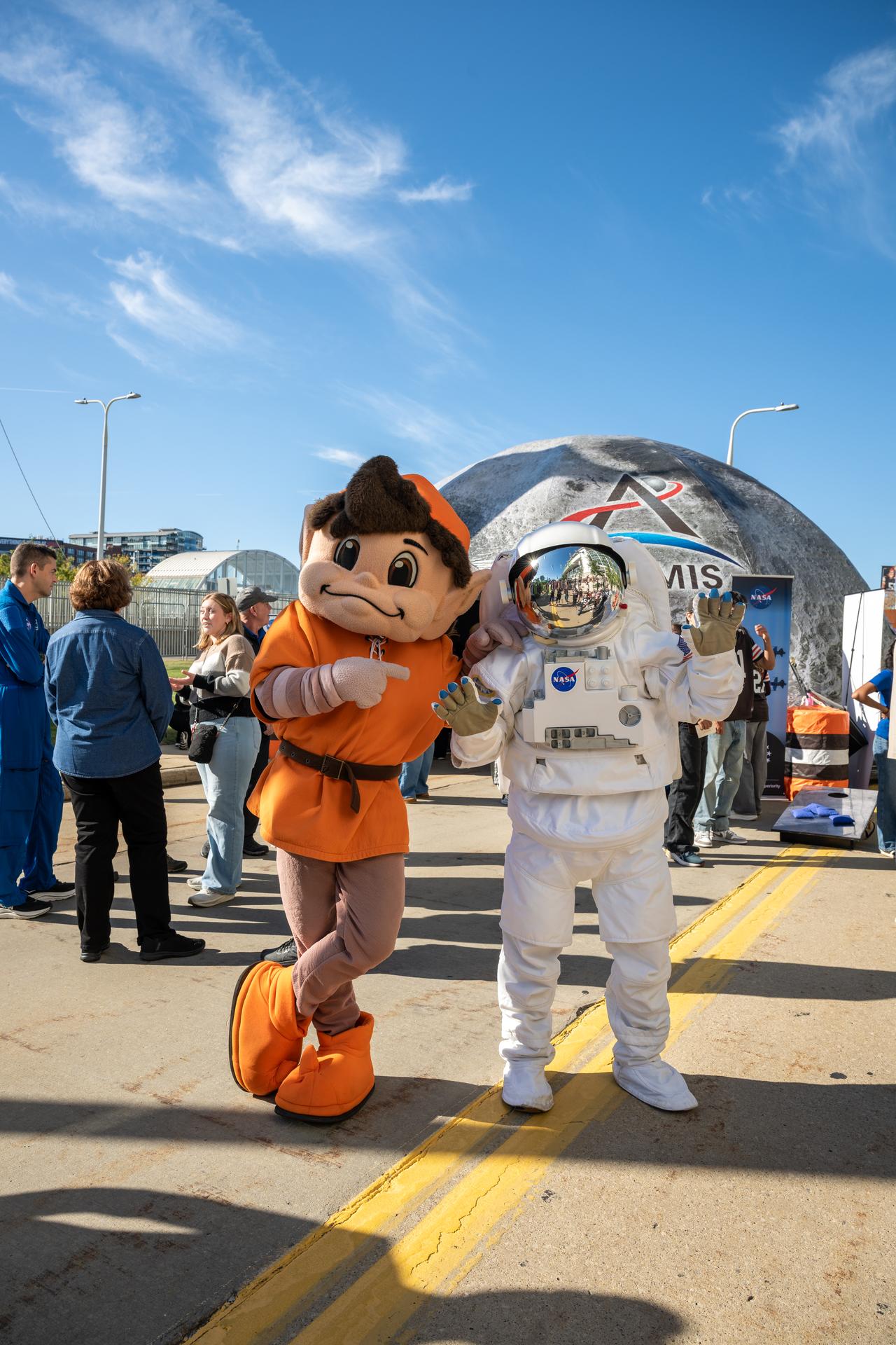 Cleveland Browns’ mascot, Brownie the Elf, poses with Eva the Astronaut at an NFL game between the Cleveland Browns and the Carolina Panthers at Huntington Bank Field, Sunday, September 27th, 2026, in Cleveland, Ohio. NASA’s engagement at NFL games is part of the agency’s Inspiration Tour, aimed at strengthening connections between NASA and its partners and showcasing innovation in air and space in the lead up to the MAX POWER aerospace technology expo and airshow at the agency’s Kennedy Space Center in early November. Photo Credit: (NASA/Jordan Cochran)