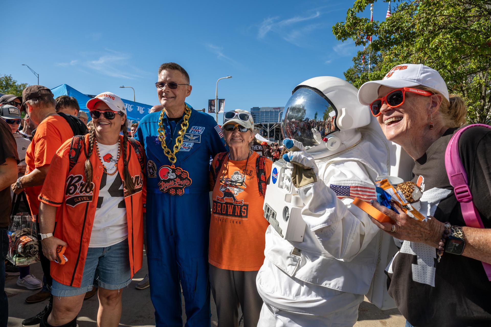 NASA Astronaut Douglas Wheelock and Eva the Astronaut pose with Browns' fans at an NFL game between the Cleveland Browns and the Carolina Panthers at Huntington Bank Field, Sunday, September 27th, 2026, in Cleveland, Ohio. NASA’s engagement at NFL games is part of the agency’s Inspiration Tour, aimed at strengthening connections between NASA and its partners and showcasing innovation in air and space in the lead up to the MAX POWER aerospace technology expo and airshow at the agency’s Kennedy Space Center in early November. Photo Credit: (NASA/Jordan Cochran)