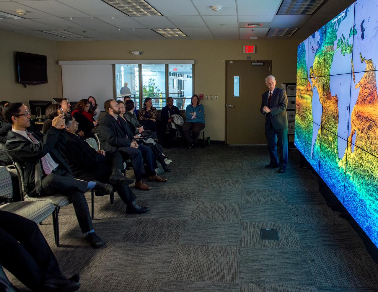 White House Office of Science & Technology Policy tours Goddard Space Flight Center. Dr. Jim Irons at the hyperwall.