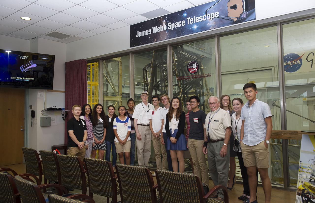 AIAA American Institute for Aeronautics and Astronautics science fair winners visited Goddard on July 17, 2017.  Dr. John Mather, Nobel Prize winner, poses with group near JWST clean room.