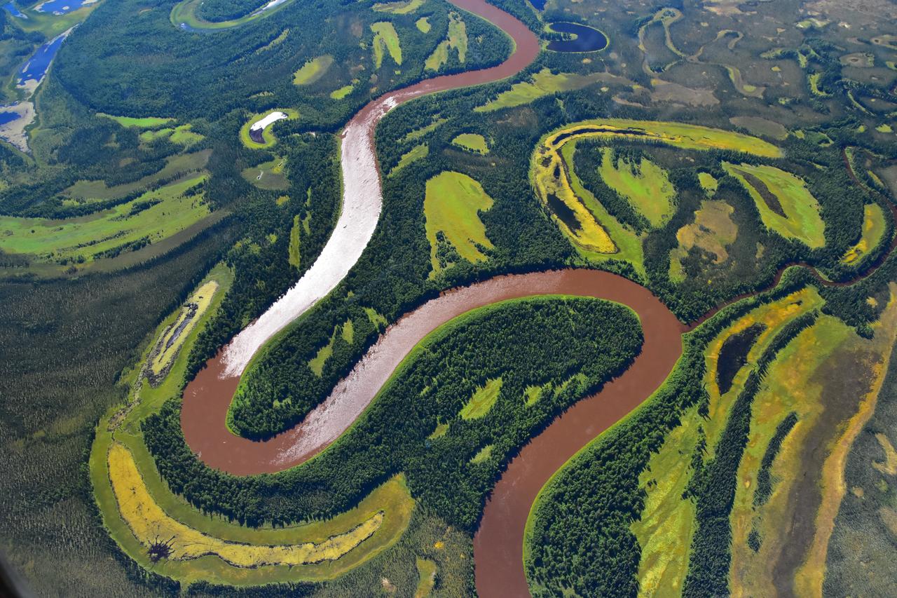 As part of the Arctic Boreal Vulnerability Experiment (ABoVE), NASA scientists are flying over Alaska and Canada, measuring the elevation of rivers and lakes to study how thawing permafrost affects hydrology in the landscape. This view of was taken from NASA’s DC-8 “flying laboratory” as part of the Active Sensing of CO2 Emissions over Nights, Days and Seasons (ASCENDS) experiment. Scientists on NASA’s Air Surface, Water and Ocean Topography (AirSWOT) mission have been flying over the same location, investigating how water levels in the Arctic landscape change as permafrost thaws. Under typical conditions, the frozen layer of soil keeps water from sinking into the ground and percolating away. As permafrost thaws, the water has new ways to move between rivers and lakes, which can raise or lower the elevation of the bodies of water. These changes in water levels will have effects on Arctic life— plants, animals, and humans—in the near future. Credit: NASA/Peter Griffith <b><a href="http://www.nasa.gov/audience/formedia/features/MP_Photo_Guidelines.html" rel="nofollow">NASA image use policy.</a></b> <b><a href="http://www.nasa.gov/centers/goddard/home/index.html" rel="nofollow">NASA Goddard Space Flight Center</a></b> enables NASA’s mission through four scientific endeavors: Earth Science, Heliophysics, Solar System Exploration, and Astrophysics. Goddard plays a leading role in NASA’s accomplishments by contributing compelling scientific knowledge to advance the Agency’s mission. <b>Follow us on <a href="http://twitter.com/NASAGoddardPix" rel="nofollow">Twitter</a></b> <b>Like us on <a href="http://www.facebook.com/pages/Greenbelt-MD/NASA-Goddard/395013845897?ref=tsd" rel="nofollow">Facebook</a></b> <b>Find us on <a href="http://instagrid.me/nasagoddard/?vm=grid" rel="nofollow">Instagram</a></b>