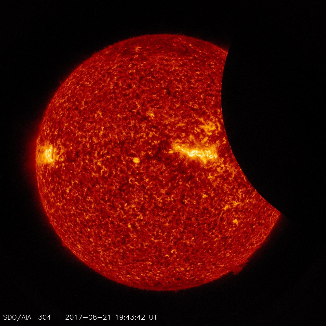 Image of the Moon transiting across the Sun, taken by SDO in 304 angstrom extreme ultraviolet light on August 21, 2017. Credit: NASA/SDO