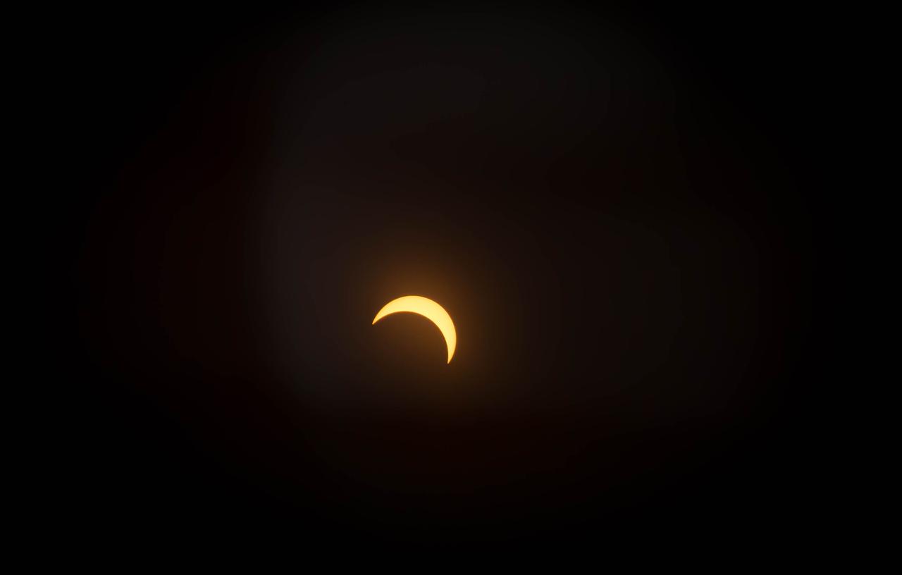View of the partial solar eclipse from NASA's Goddard Space Flight Center in Greenbelt, Md on Monday, August 21, 2017.   A total solar eclipse swept across a narrow portion of the contiguous United States from Lincoln Beach, Oregon to Charleston, South Carolina. A partial solar eclipse was visible across the entire North American continent along with parts of South America, Africa, and Europe.    Credit: NASA/Goddard/Rebecca Roth
