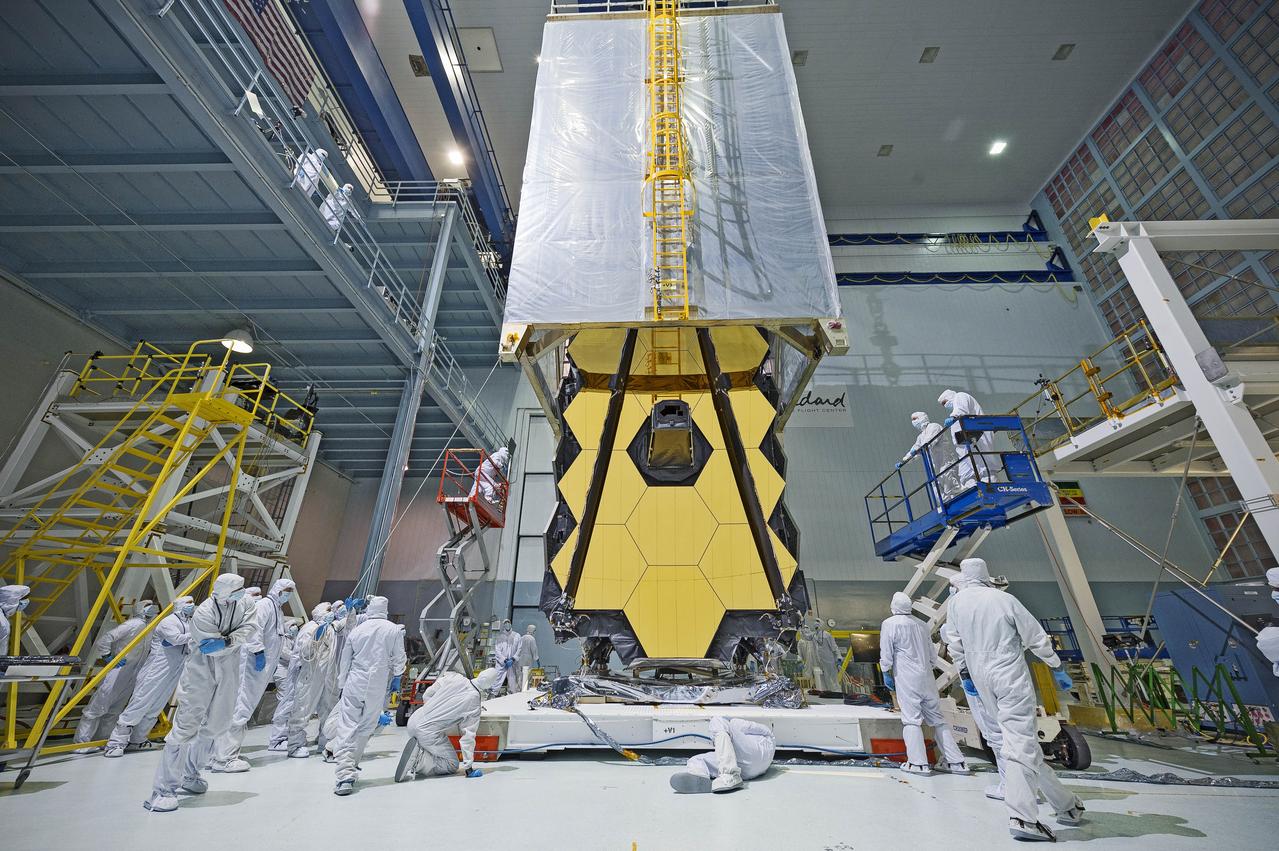 What looks like a teleporter from science fiction being draped over NASA's James Webb Space Telescope, is actually a &quot;clean tent.&quot; The clean tent protects Webb from dust and dirt when engineers at NASA's Goddard Space Flight Center in Greenbelt, Maryland transport the next generation space telescope out of the relatively dust-free cleanroom and into the shirtsleeve environment of the vibration and acoustics testing areas. In two years, a rocket will be the transporter that carries the Webb into space so it can orbit one million miles from Earth and peer back over 13.5 billion years to see the first stars and galaxies forming out of the darkness of the early universe.  For more information about the Webb telescope, visit: <a href="http://www.jwst.nasa.gov" rel="nofollow">www.jwst.nasa.gov</a> or <a href="http://www.nasa.gov/webb" rel="nofollow">www.nasa.gov/webb</a>.  Photo Credit: NASA/Goddard/Chris Gunn  <b><a href="http://www.nasa.gov/audience/formedia/features/MP_Photo_Guidelines.html" rel="nofollow">NASA image use policy.</a></b>  <b><a href="http://www.nasa.gov/centers/goddard/home/index.html" rel="nofollow">NASA Goddard Space Flight Center</a></b> enables NASA’s mission through four scientific endeavors: Earth Science, Heliophysics, Solar System Exploration, and Astrophysics. Goddard plays a leading role in NASA’s accomplishments by contributing compelling scientific knowledge to advance the Agency’s mission.  <b>Follow us on <a href="http://twitter.com/NASAGoddardPix" rel="nofollow">Twitter</a></b>  <b>Like us on <a href="http://www.facebook.com/pages/Greenbelt-MD/NASA-Goddard/395013845897?ref=tsd" rel="nofollow">Facebook</a></b>  <b>Find us on <a href="http://instagrid.me/nasagoddard/?vm=grid" rel="nofollow">Instagram</a></b>          