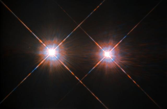 The closest star system to the Earth is the famous Alpha Centauri group. Located in the constellation of Centaurus (The Centaur), at a distance of 4.3 light-years, this system is made up of the binary formed by the stars Alpha Centauri A and Alpha Centauri B, plus the faint red dwarf Alpha Centauri C, also known as Proxima Centauri.  This NASA/ESA Hubble Space Telescope has given us this stunning view of the bright Alpha Centauri A (on the left) and Alpha Centauri B (on the right), shining like huge cosmic headlamps in the dark. The image was captured by the Wide-Field and Planetary Camera 2 (WFPC2). WFPC2 was Hubble’s most used instrument for the first 13 years of the space telescope’s life, being replaced in 2009 by Wide-Field Camera 3 (WFC3) during Servicing Mission 4. This portrait of Alpha Centauri was produced by observations carried out at optical and near-infrared wavelengths.  Compared to the sun, Alpha Centauri A is of the same stellar type, G2, and slightly bigger, while Alpha Centauri B, a K1-type star, is slightly smaller. They orbit a common center of gravity once every 80 years, with a minimum distance of about 11 times the distance between Earth and the sun. Because these two stars are, together with their sibling Proxima Centauri, the closest to Earth, they are among the best studied by astronomers. And they are also among the prime targets in the hunt for habitable exoplanets.  Using the European Space Organization's HARPS instrument, astronomers already discovered a planet orbiting Alpha Centauri B.  Then on Aug. 24, 2016, astronomers announced the intriguing discovery of a nearly Earth-sized planet in the habitable zone orbiting the star Proxima Centauri  Image credit: ESA/NASA 