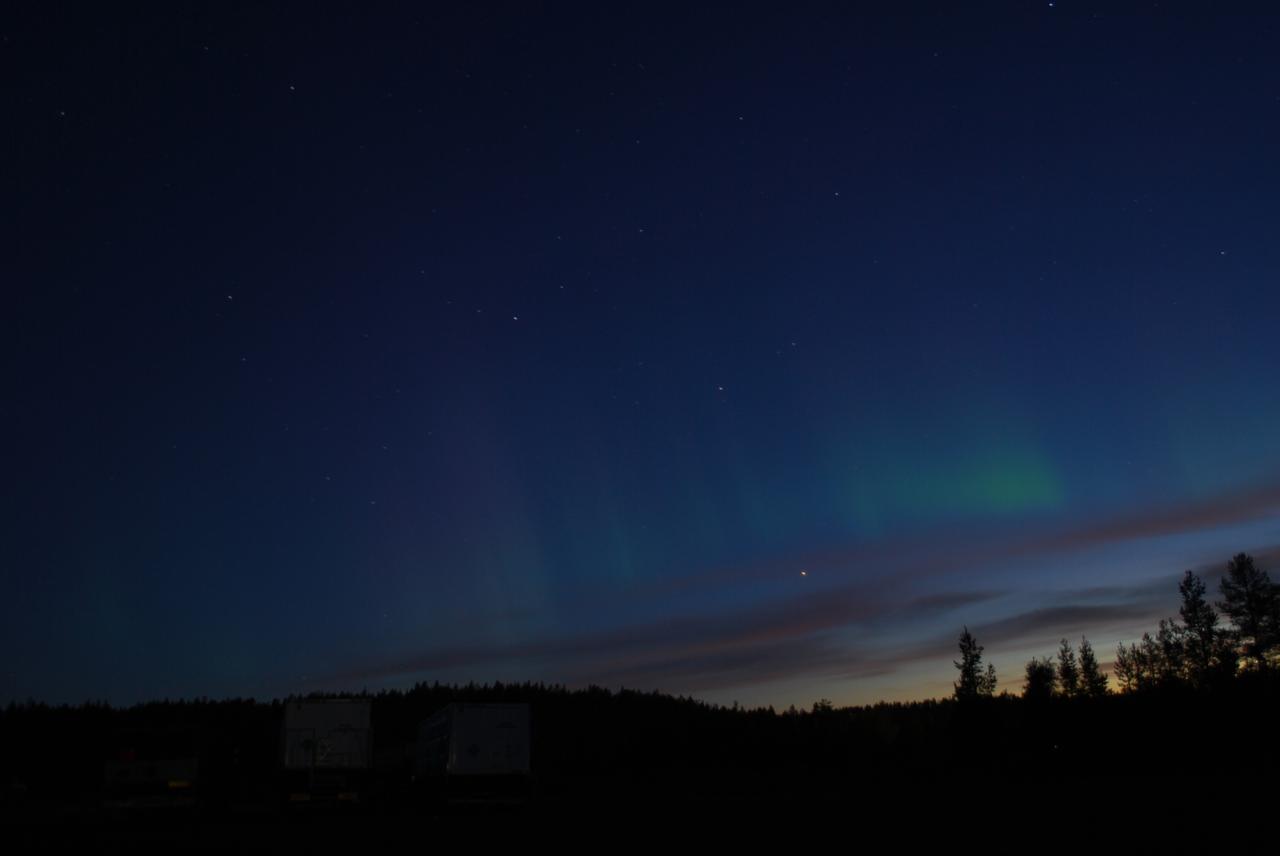 The faint green glow of aurora can be seen above the clouds at Esrange Space Center in this photo from Aug. 23, 2016. Auroras are created by energetic electrons, which rain down from Earth’s magnetic bubble and interact with particles in the upper atmosphere to create glowing lights that stretch across the sky.  The BARREL team is at Esrange Space Center near Kiruna, Sweden, launching a series of six scientific payloads on miniature scientific balloons. The NASA-funded BARREL – which stands for Balloon Array for Radiation-belt Relativistic Electron Losses – primarily measures X-rays in Earth’s atmosphere near the North and South Poles. These X-rays are produced by electrons raining down into the atmosphere from two giant swaths of radiation that surround Earth, called the Van Allen belts. Learning about the radiation near Earth helps us to better protect our satellites.   Several of the BARREL balloons also carry instruments built by undergraduate students to measure the total electron content of Earth’s ionosphere, as well as the low-frequency electromagnetic waves that help to scatter electrons into Earth’s atmosphere. Though about 90 feet in diameter, the BARREL balloons are much smaller than standard football stadium-sized scientific balloons.  This is the fourth campaign for the BARREL mission. BARREL is led by Dartmouth College in Hanover, New Hampshire. The undergraduate student instrument team is led by the University of Houston and funded by the Undergraduate Student Instrument Project out of NASA’s Wallops Flight Facility. For more information on NASA’s scientific balloon program, visit: <a href="http://www.nasa.gov/scientificballoons" rel="nofollow">www.nasa.gov/scientificballoons</a>.   Credit: NASA/University of Houston/Michael Greer   <b><a href="http://www.nasa.gov/audience/formedia/features/MP_Photo_Guidelines.html" rel="nofollow">NASA image use policy.</a></b>  <b><a href="http://www.nasa.gov/centers/goddard/home/index.html" rel="nofollow">NASA Goddard Space Flight Center</a></b> enables NASA’s mission through four scientific endeavors: Earth Science, Heliophysics, Solar System Exploration, and Astrophysics. Goddard plays a leading role in NASA’s accomplishments by contributing compelling scientific knowledge to advance the Agency’s mission.  <b>Follow us on <a href="http://twitter.com/NASAGoddardPix" rel="nofollow">Twitter</a></b>  <b>Like us on <a href="http://www.facebook.com/pages/Greenbelt-MD/NASA-Goddard/395013845897?ref=tsd" rel="nofollow">Facebook</a></b>  <b>Find us on <a href="http://instagrid.me/nasagoddard/?vm=grid" rel="nofollow">Instagram</a></b>    