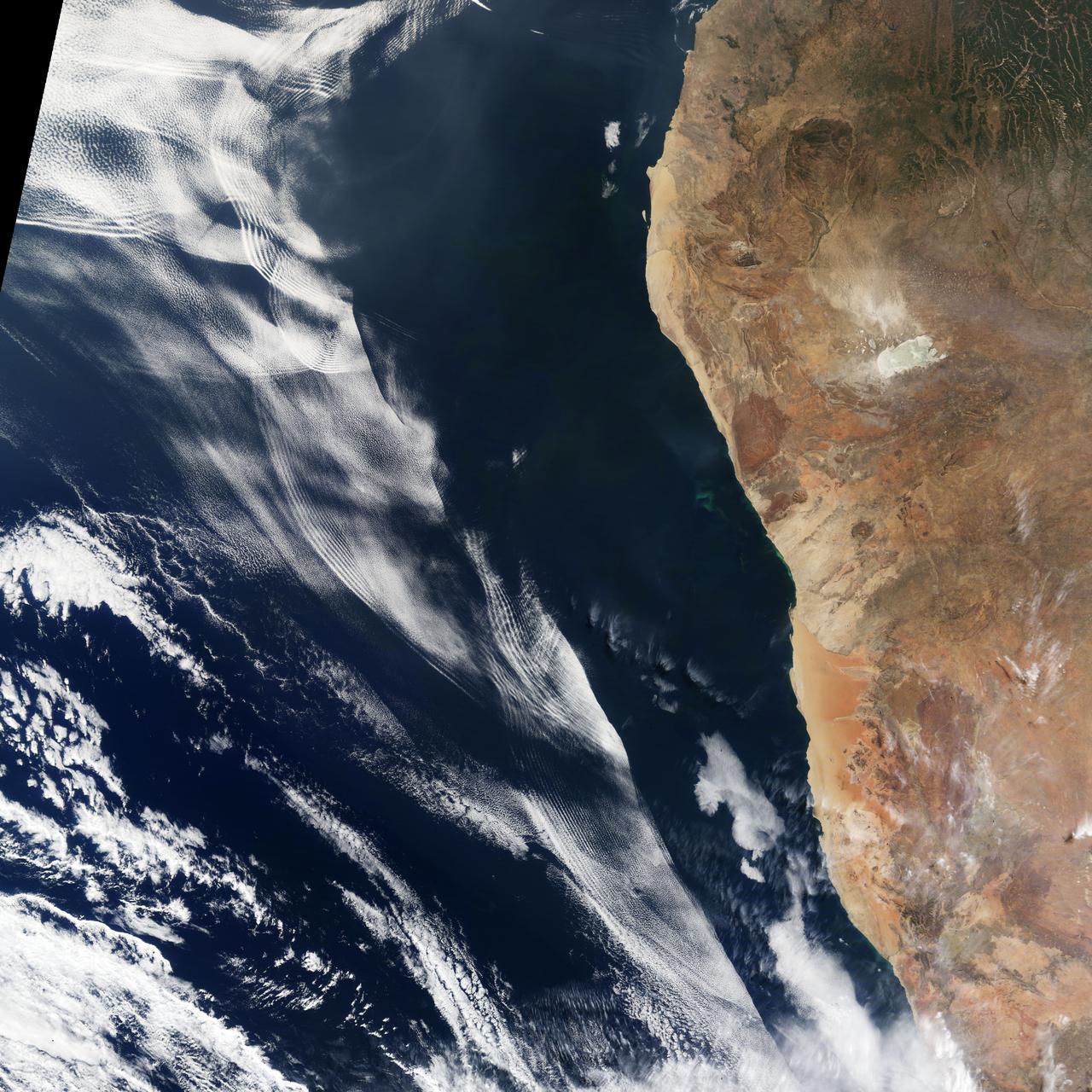 On June 26, 2016, the Moderate Resolution Imaging Spectroradiometer (MODIS) on NASA’s Terra satellite acquired this natural-color image of cloud gravity waves off the coast of Angola and Namibia.  “I [regularly] look at this area on Worldview because you quite often have these gravity waves,” said Bastiaan Van Diedenhoven, a researcher for Columbia University and NASA's Goddard Institute for Space Studies interested in cloud formations. “On this day, there was so much going on—so many different waves from different directions—that they really started interfering.” A distinctive criss-cross pattern formed in unbroken stretches hundreds of kilometers long.  Similar to a boat’s wake, which forms as the water is pushed upward by the boat and pulled downward again by gravity, these clouds are formed by the rise and fall of colliding air columns.  Off of west Africa, dry air coming off the Namib desert—after being cooled by the night—moves out under the balmy, moist air over the ocean and bumps it upwards. As the humid air rises to a higher altitude, the moisture condenses into droplets, forming clouds. Gravity rolls these newly formed clouds into a wave-like shape. When moist air goes up, it cools, and then gravity pushes it down again. As it plummets toward the earth, the moist air is pushed up again by the dry air. Repeated again and again, this process creates gravity waves. Clouds occur at the upward wave motions, while they evaporate at the downward motions.  Such waves will often propagate in the morning and early afternoon, said Van Diedenhoven. During the course of the day, the clouds move out to sea and stretch out, as the dry air flowing off the land pushes the moist ocean air westward.  NASA Earth Observatory image by Jesse Allen, using data from the Land Atmosphere Near real-time Capability for EOS (LANCE).  via @NASAEarth <a href="http://go.nasa.gov/29Btxcy" rel="nofollow">go.nasa.gov/29Btxcy</a>  <b><a href="http://go.nasa.gov/29BtHR6" rel="nofollow">NASA image use policy.</a></b>  <b><a href="http://go.nasa.gov/29BtDku" rel="nofollow">NASA Goddard Space Flight Center</a></b> enables NASA’s mission through four scientific endeavors: Earth Science, Heliophysics, Solar System Exploration, and Astrophysics. Goddard plays a leading role in NASA’s accomplishments by contributing compelling scientific knowledge to advance the Agency’s mission.  <b>Follow us on <a href="http://go.nasa.gov/29BtVrn" rel="nofollow">Twitter</a></b>  <b>Like us on <a href="http://go.nasa.gov/29BtygK" rel="nofollow">Facebook</a></b>  <b>Find us on <a href="http://go.nasa.gov/29Bu0vu" rel="nofollow">Instagram</a></b>   