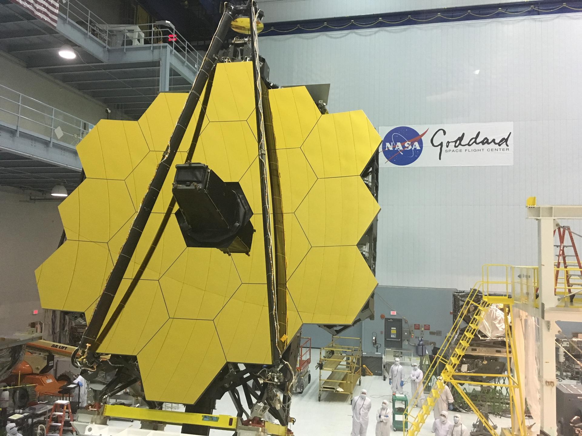 The James Webb Space Telescope golden mirrors, made up up 18 golden hexagon shapes, in a cleanroom at Goddard.