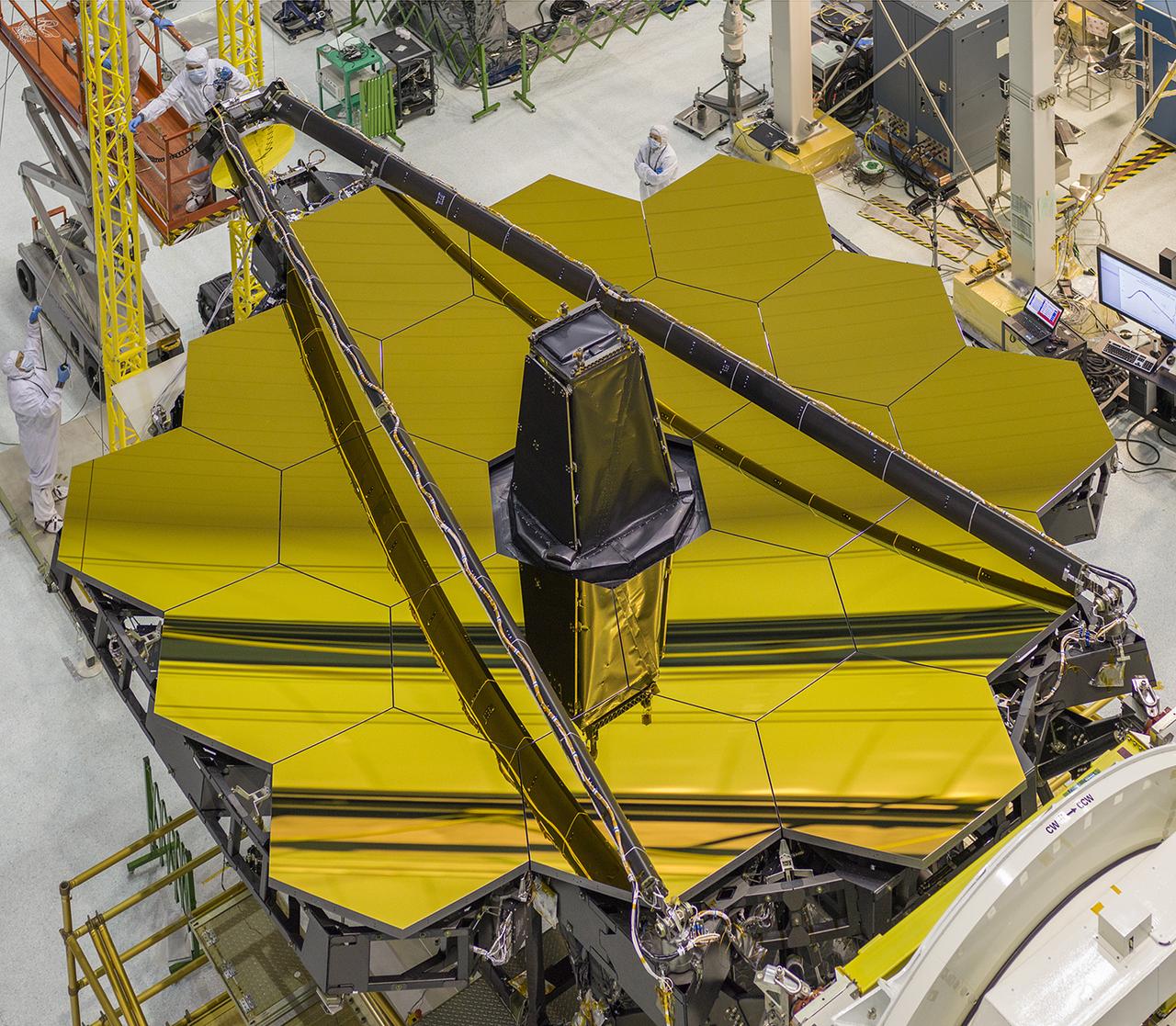 Here's a view from overhead of the golden James Webb Space Telescope, with its secondary mirror booms stowed. This is the position the secondary mirror will be in during launch. Preparations are being done to rotate the telescope in order to install the flight instrument module behind the primary mirror.   JWST's mirrors are covered in a microscopically thin layer of gold, which optimizes them for reflecting infrared light, which is the primary wavelength of light this telescope will observe.   Image credit: NASA/Goddard/Chris Gunn  <b><a href="http://www.nasa.gov/audience/formedia/features/MP_Photo_Guidelines.html" rel="nofollow">NASA image use policy.</a></b>  <b><a href="http://www.nasa.gov/centers/goddard/home/index.html" rel="nofollow">NASA Goddard Space Flight Center</a></b> enables NASA’s mission through four scientific endeavors: Earth Science, Heliophysics, Solar System Exploration, and Astrophysics. Goddard plays a leading role in NASA’s accomplishments by contributing compelling scientific knowledge to advance the Agency’s mission.  <b>Follow us on <a href="http://twitter.com/NASAGoddardPix" rel="nofollow">Twitter</a></b>  <b>Like us on <a href="http://www.facebook.com/pages/Greenbelt-MD/NASA-Goddard/395013845897?ref=tsd" rel="nofollow">Facebook</a></b>  <b>Find us on <a href="http://instagrid.me/nasagoddard/?vm=grid" rel="nofollow">Instagram</a></b> 