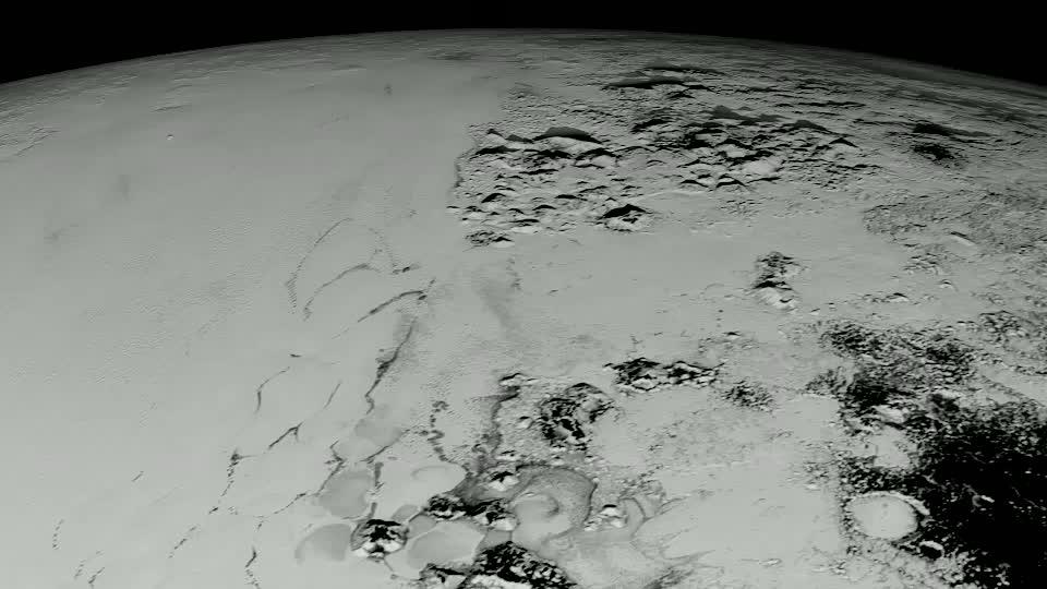 Pluto has long been a mystery, a dot at our solar system’s margins. The best images, even with NASA’s Hubble Space Telescope, were fuzzy and pixelated. In July 2015, NASA’s New Horizons spacecraft flew past Pluto and captured the sharpest views of the dwarf planet to date. One of the most striking areas, informally named &quot;Sputnik Planum,&quot; is a sweeping, frozen plain the size of Texas and ringed by mountains of ice. Its smooth deposits are unmarred by impact craters, a stark contrast to the rest of Pluto’s battered surface. As a result, scientists believe the region formed recently, within the last few hundred million years. This contradicts past depictions of Pluto as an unchanging world. By analyzing images taken during the flyby, scientists hope to unravel more of the dwarf planet’s history. Watch the video for an up-close look at Pluto.  Credit: NASA's Goddard Space Flight Center  Video courtesy of NASA/Johns Hopkins University Applied Physics Laboratory/Southwest Research Institute/S. Robbins   